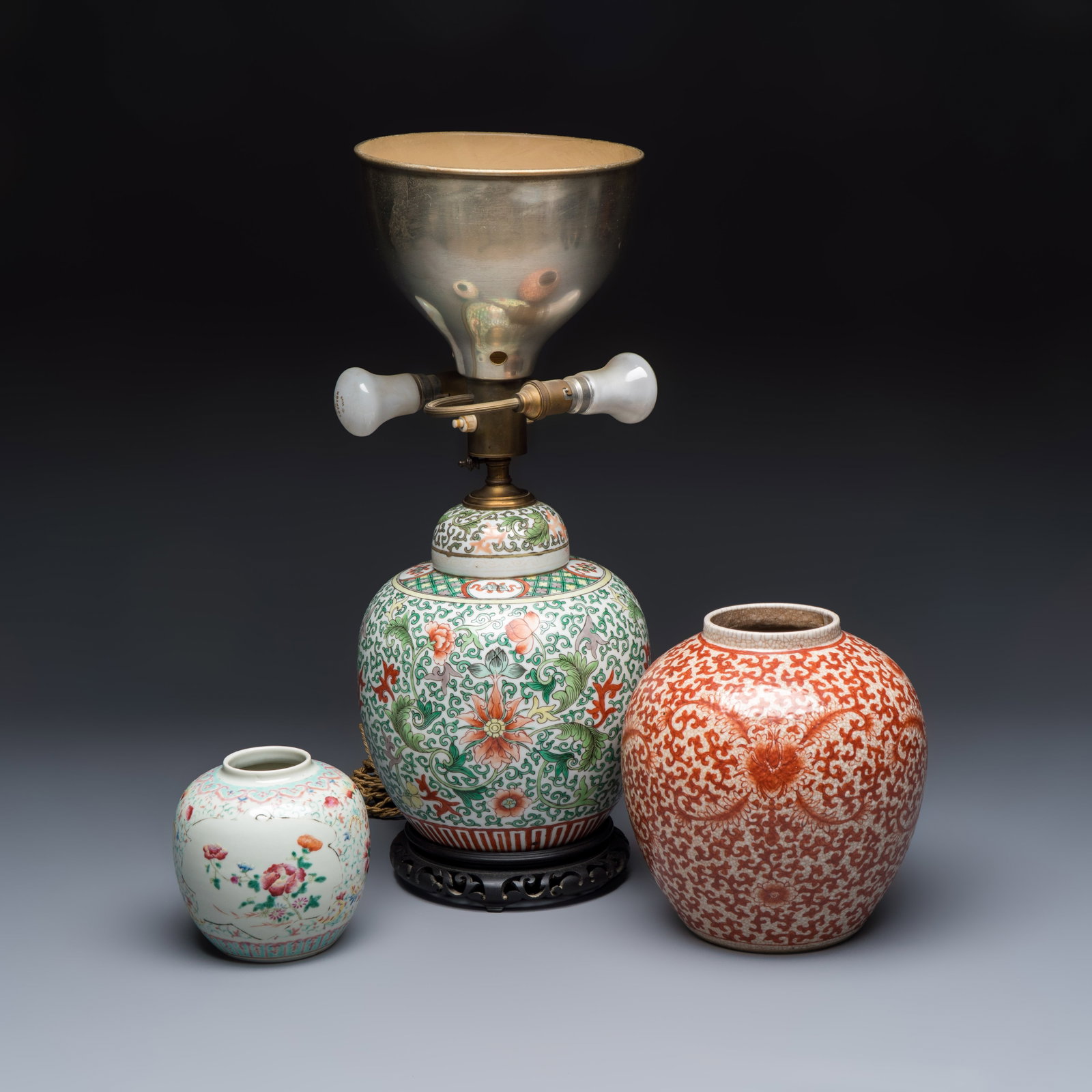 Three Chinese famille rose, verte and iron-red-decorated jars, one mounted as a lamp, 19th C.: Three Chinese famille rose, verte and iron-red-decorated jars, one mounted as a lamp, 19th C. H.: 53,5 cm | the tallest, incl. mount H.: 13 cm | the smallest