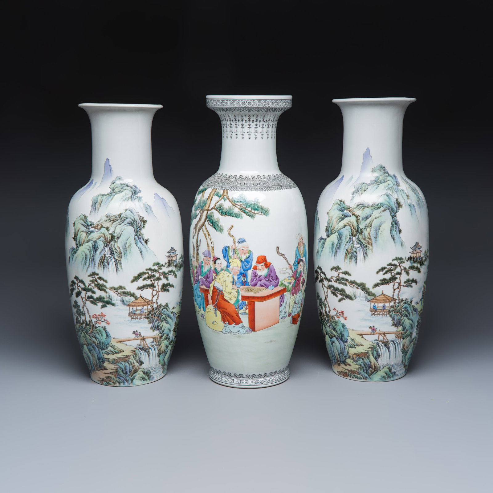A pair of Chinese famille rose 'Landscape' vases and an 'Immortals' vase, Qianlong and Guang Hua Yi: A pair of Chinese famille rose 'Landscape' vases and an 'Immortals' vase, Qianlong and Guang Hua Yi Pin marks, 20th C. H.: 61,5 cm | the tallest H.: 60 cm | the smallest