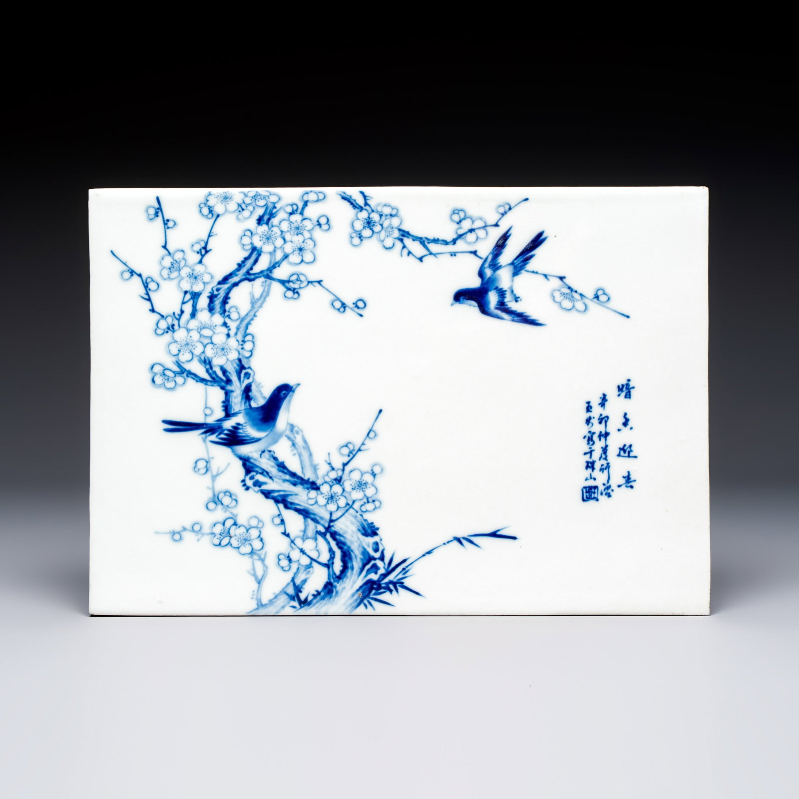 A Chinese blue and white 'Birds Among Flowering Branches' plaque after Wang Bu, 20th C. (1 of 2)