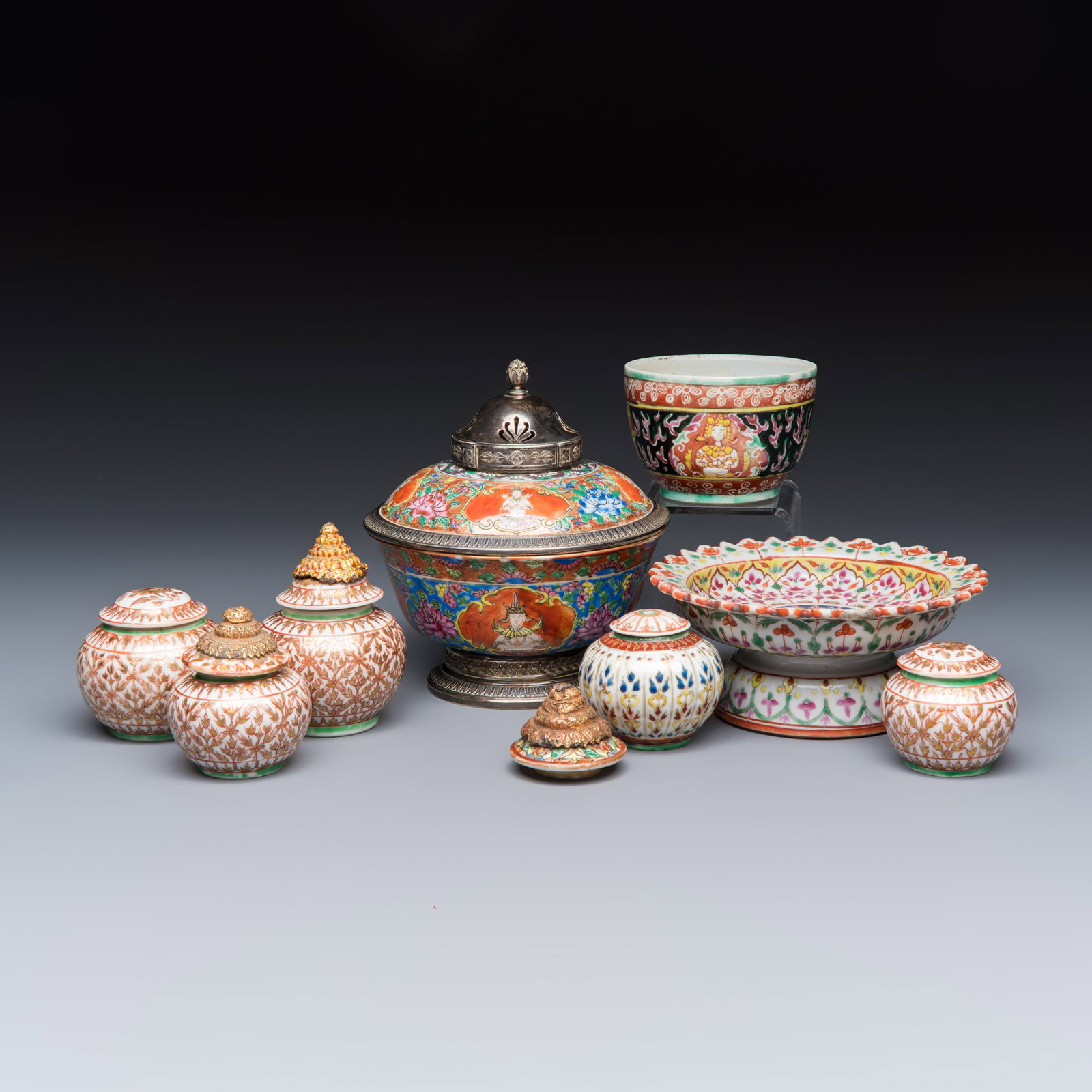 A group of nine Chinese Bencharong wares for the Thai market, 19th C.: A group of nine Chinese Bencharong wares for the Thai market, 19th C. Dia.: 13,6 cm - H.: 15 cm | the silver-mounted bowl, incl. cover Dia.: 14,3 cm - H.: 6,3 cm | the tazza H.: 8,8 cm | the largest j