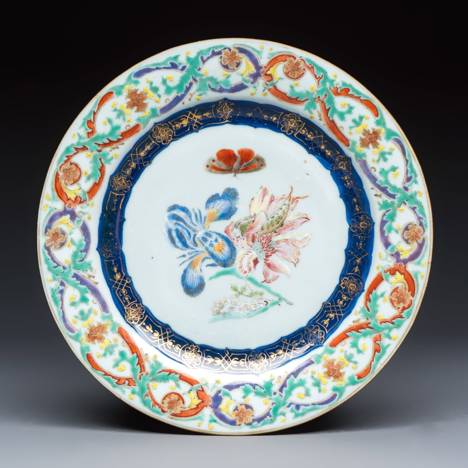 A Chinese famille rose 'Botanical' plate based on designs by the German botanist Maria Sybille (1 of 2)