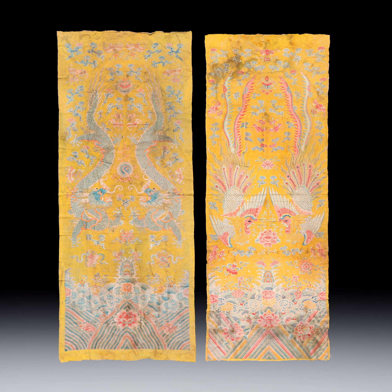 A pair of Chinese yellow-ground embroidered 'Dragons' and 'Phoenixes' panels, 19th C.: A pair of Chinese yellow-ground embroidered 'Dragons' and 'Phoenixes' panels, 19th C. Dim: 194 x 77 cm | the largest Dim: 186 x 68 cm | the smallest