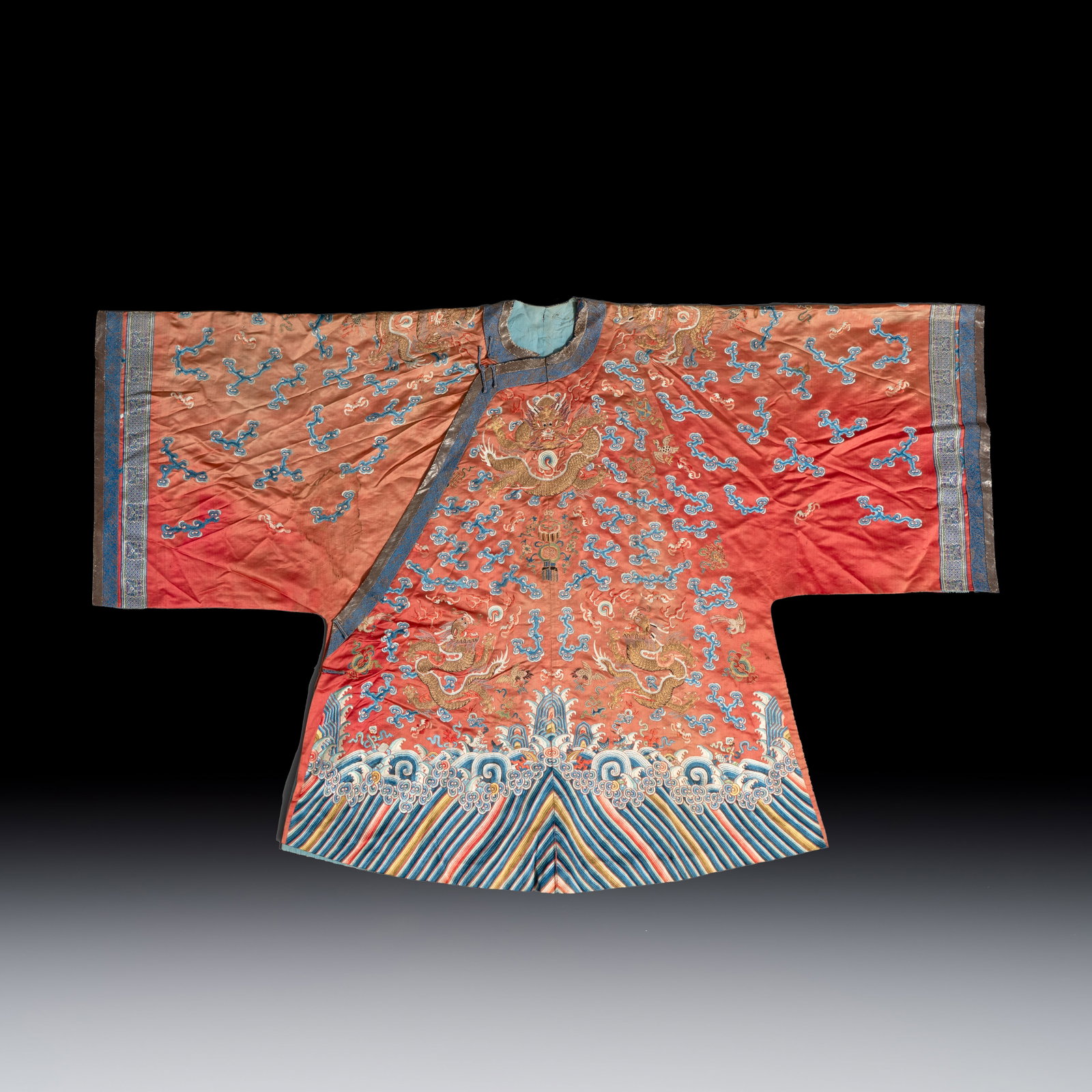 A Chinese red-ground silk embroidered 'Dragons' robe for a lady, 19th C. (1 of 2)