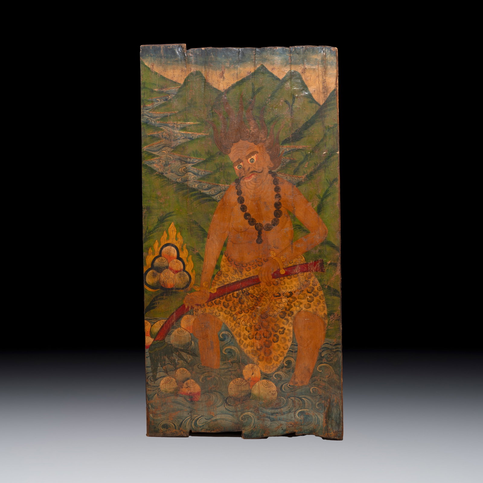 A large Tibetan polychrome-painted wood 'Guardian' panel or door, 19th C. (1 of 2)