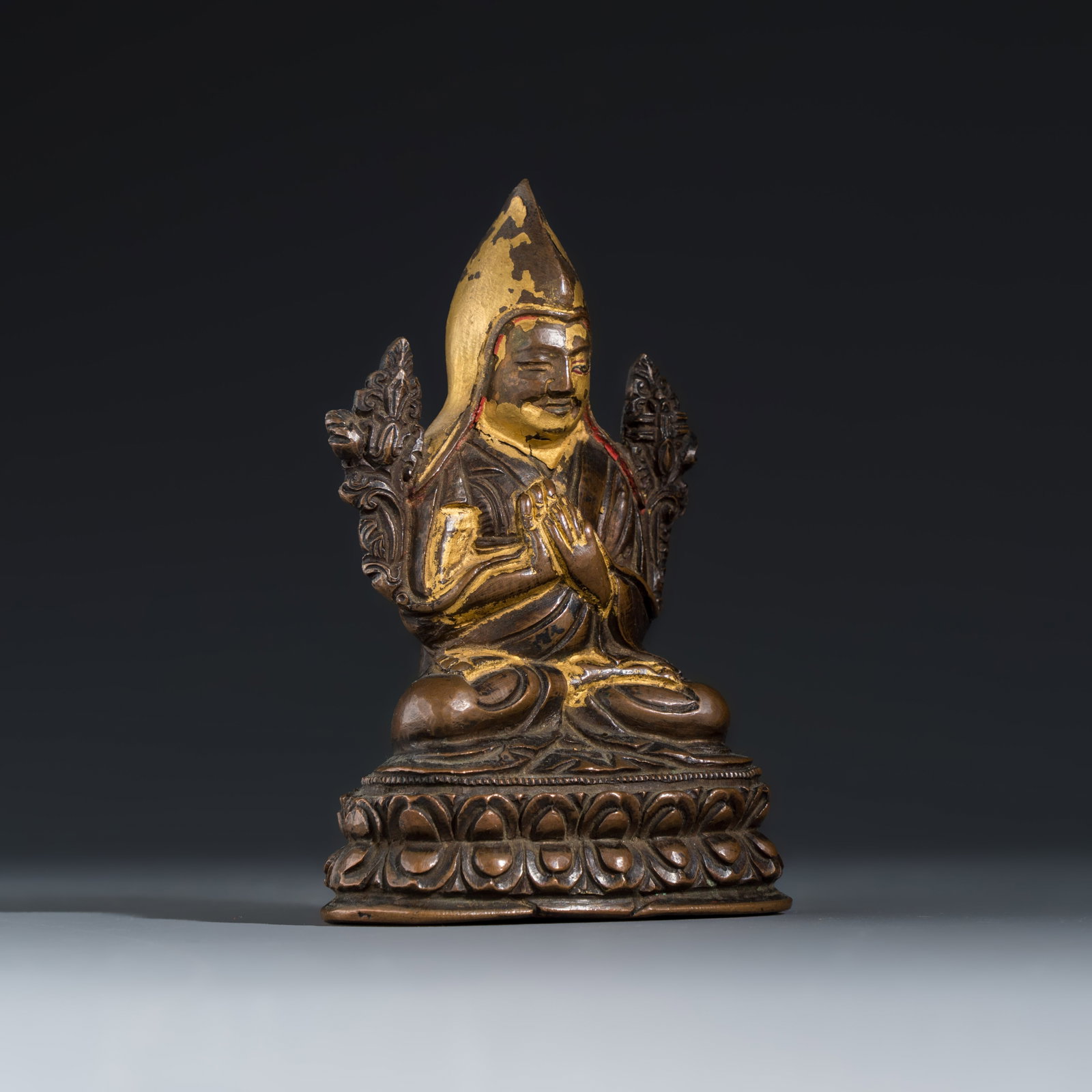 A Tibetan gilt-lacquered copper-alloy figure of Tsongkhapa seated on a lotus base, 19/20th C. (1 of 7)