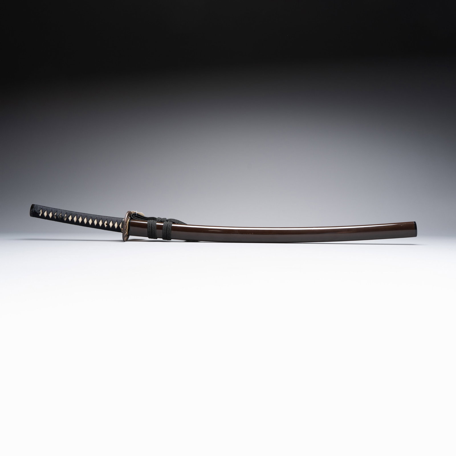 A Japanese katana, signed Ishid? Teruhide saku, with koshirae and shirasaya, Sh?wa, 20th C.: A Japanese katana, signed Ishid? Teruhide saku, with koshirae and shirasaya, Sh?wa, 20th C. H.: 99 cm | koshirae L.: 88,9 cm | nagasa L.: 2,1 cm | saki-haba L.: 3,2 cm | moto-haba