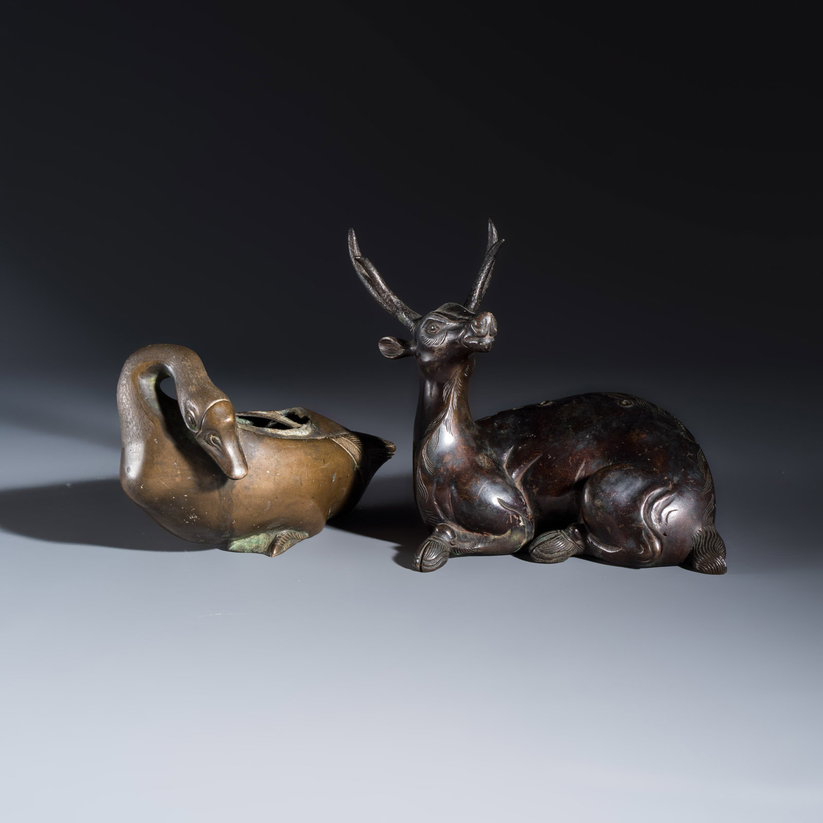 A Chinese bronze 'Goose' incense burner and a 'Stag' incense burner, 19th C.: A Chinese bronze 'Goose' incense burner and a 'Stag' incense burner, 19th C. Dim: 20,1 x 13 x 16,6 cm | the stag Dim: 18 x 9,8 x 11,4 cm | the goose Total weight: 2716 grams