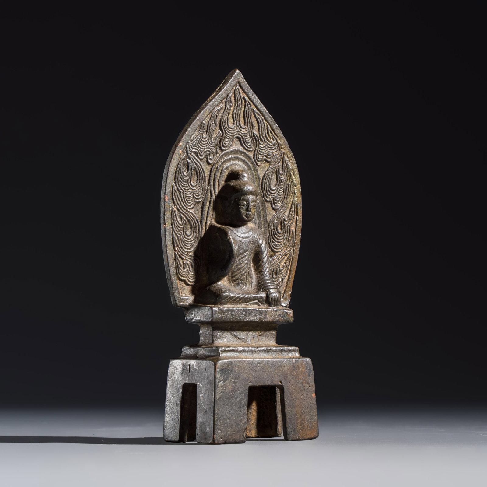 A Chinese bronze seated Buddha with a flaming halo, 19/20th C. (1 of 8)