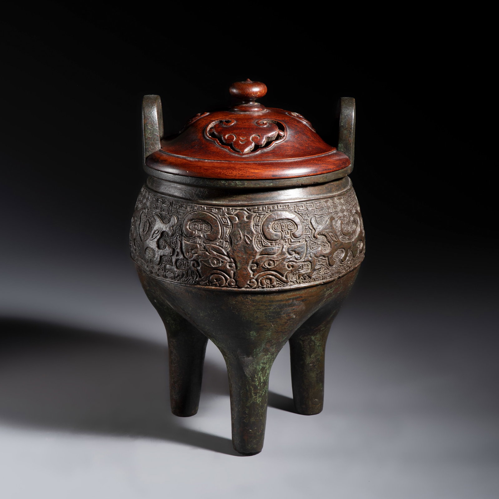 An inscribed Chinese archaistic bronze tripod incense burner with hongmu cover, Ming (1 of 9)