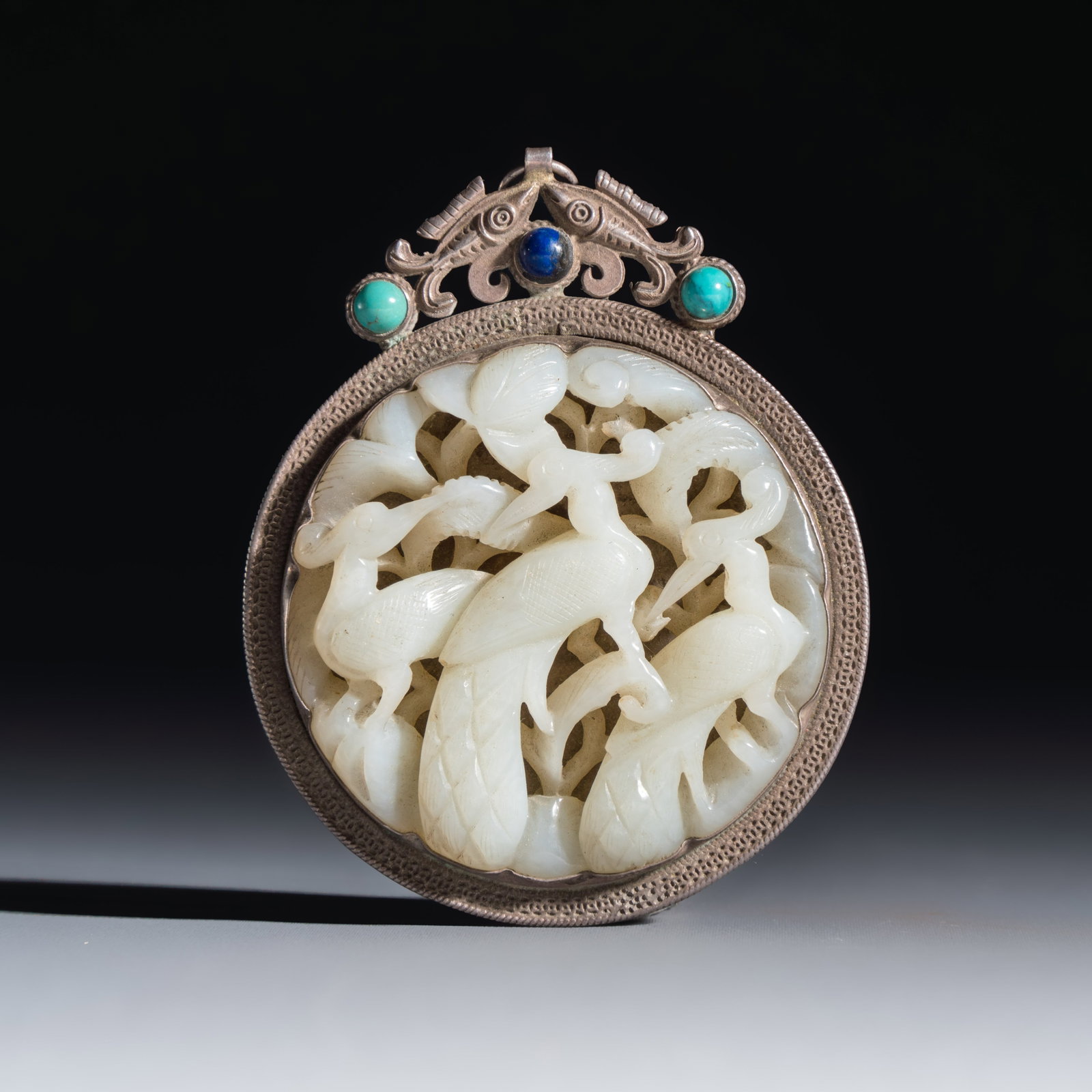 A Chinese silver-mounted openwork jade plaque with birds, Qing (1 of 2)