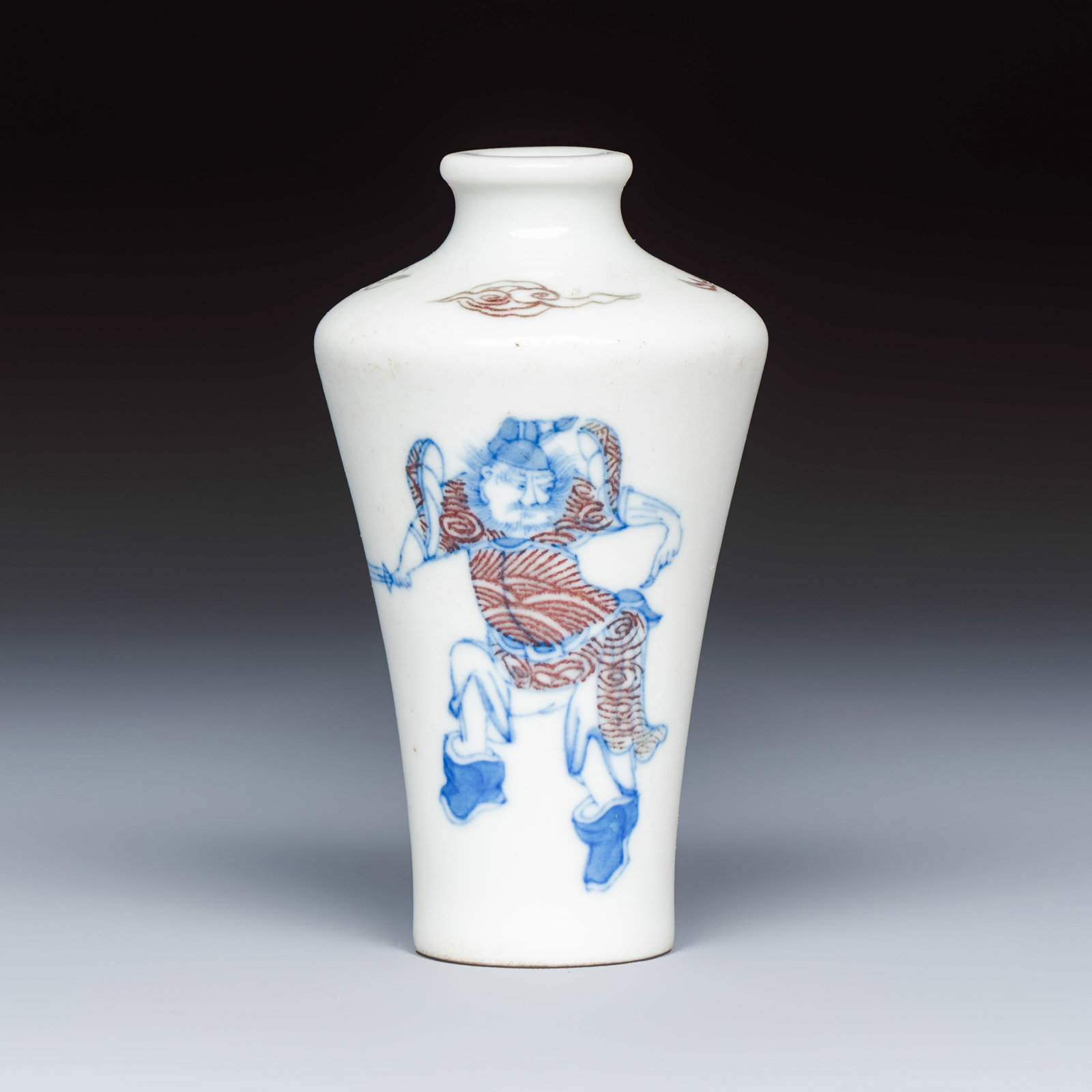A Chinese blue, white and copper-red 'Zhong Kui' snuff bottle, Guangxu mark and of the period: A Chinese blue, white and copper-red 'Zhong Kui' snuff bottle, Guangxu mark and of the period H.: 9,2 cm