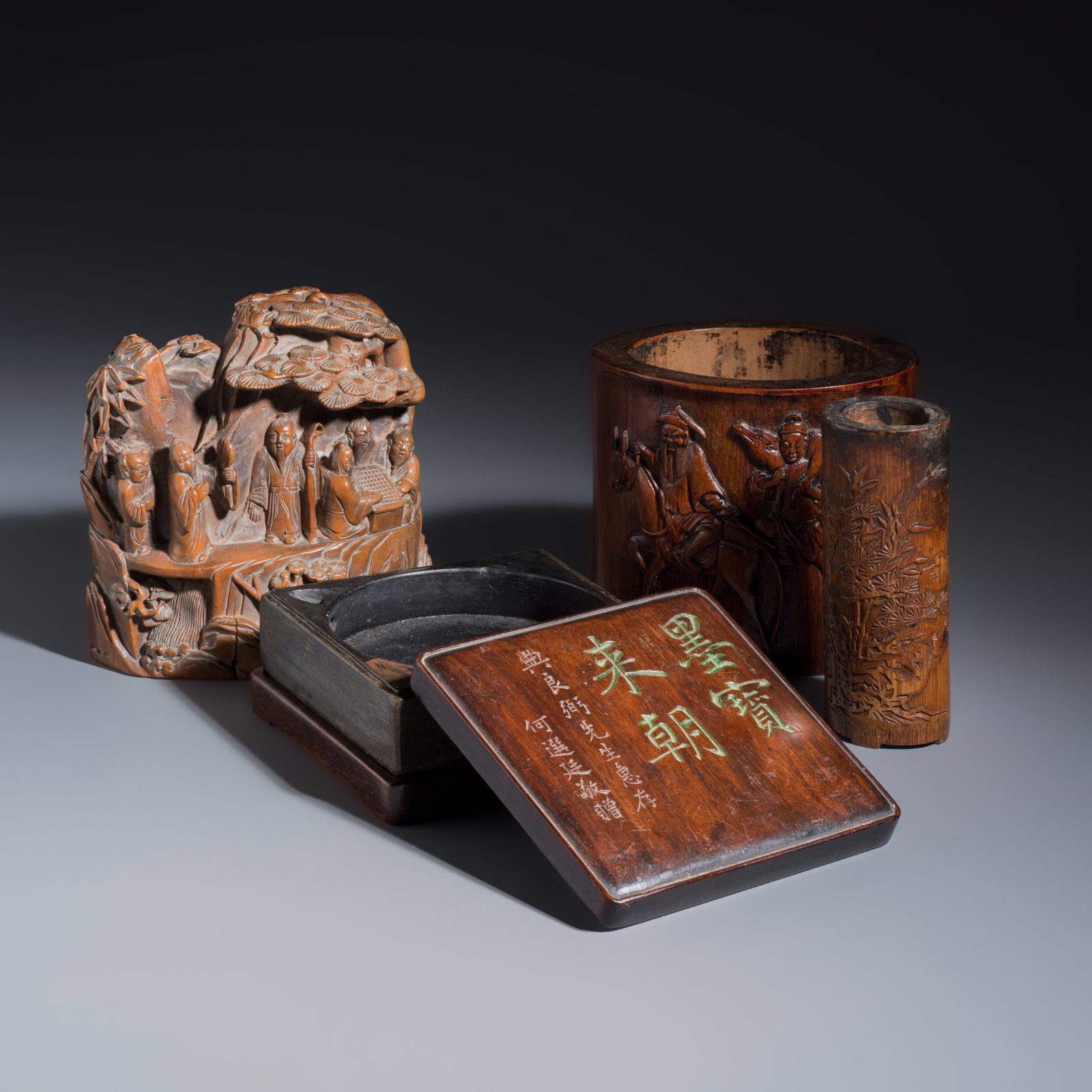 A Chinese inkstone with hongmu cover and stand, a boxwood carving, a bamboo brushpot and an incense: A Chinese inkstone with hongmu cover and stand, a boxwood carving, a bamboo brushpot and an incense tube, 19/20th C. Dim: 12,1 x 9,4 x 11,2 cm | the brushpot Dim: 12 x 12 x 5,7 cm | the inkstone, incl