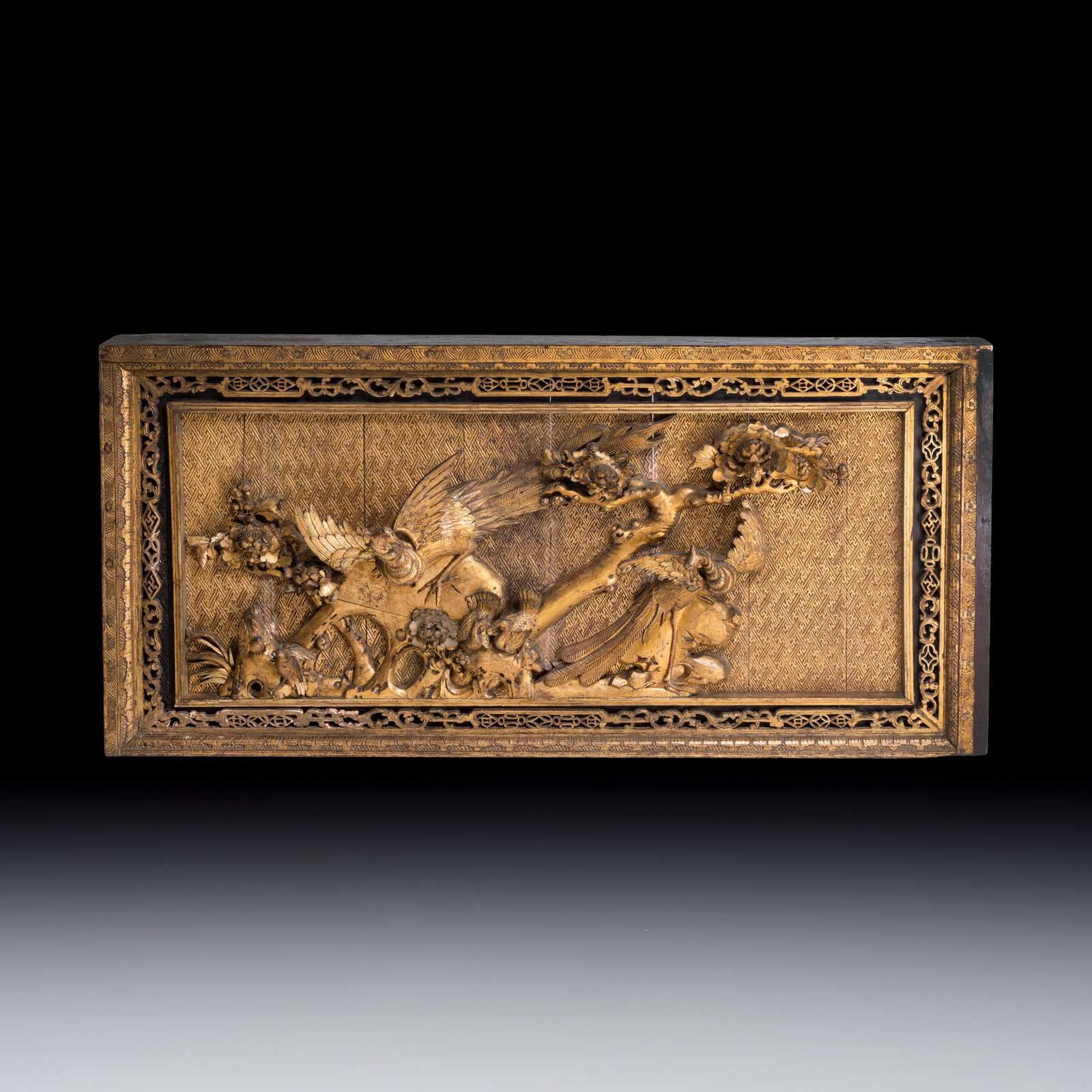 A large Chinese carved gilt wooden panel with birds among peonies, 19th C.: A large Chinese carved gilt wooden panel with birds among peonies, 19th C. Dim: 93 x 188 cm