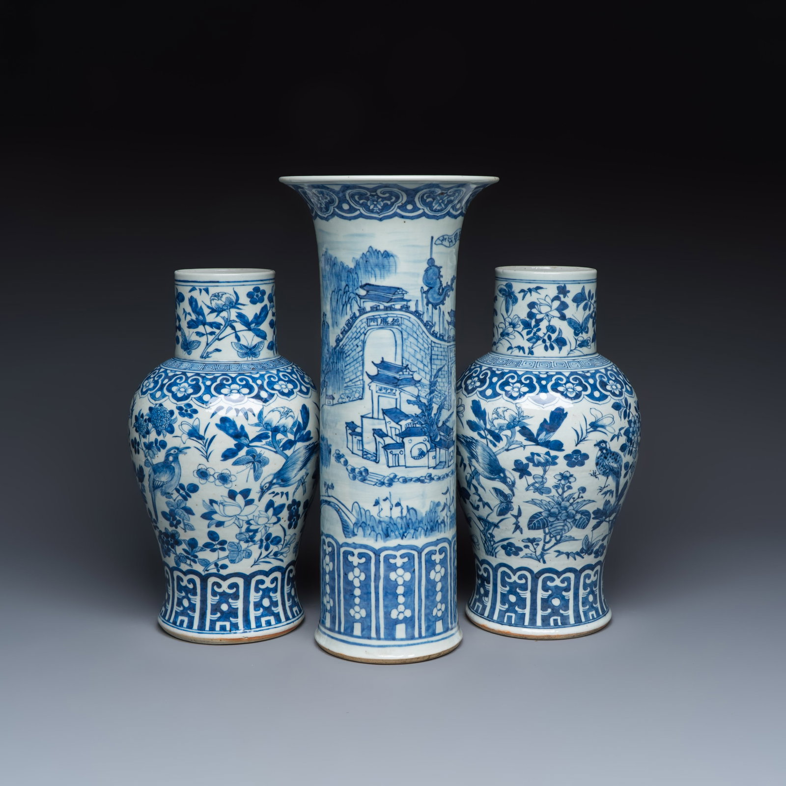 A Chinese blue and white 'Landscape' vase and a pair of 'Birds among Flowering Branches' vases, 19th: A Chinese blue and white 'Landscape' vase and a pair of 'Birds among Flowering Branches' vases, 19th C. H.: 44,7 cm | the tallest H.: 35,9 cm | the smallest