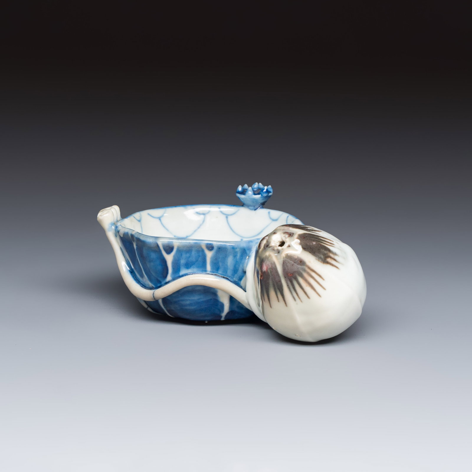 A Chinese blue, white and copper-red lotus-form water dropper, Kangxi: A Chinese blue, white and copper-red lotus-form water dropper, Kangxi Dim: 12,5 x 9 x 6 cm Ref.: The Rijksmuseum, The Netherlands, registration no. AK-RAK-1972-3 for a similar example.