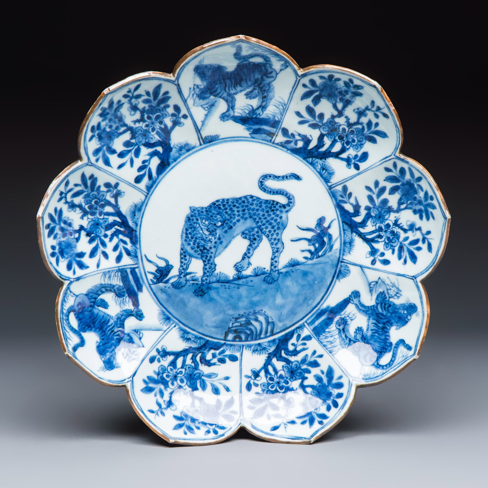 A rare Chinese blue and white lotus-shaped 'Leopard' dish, Kangxi: A rare Chinese blue and white lotus-shaped 'Leopard' dish, Kangxi Dia.: 25,2 cm Ref.: An identical pair is in the Frelinghuys Collection, illustrated by Becky MacGuire in ''Four Centuries of Blue and 