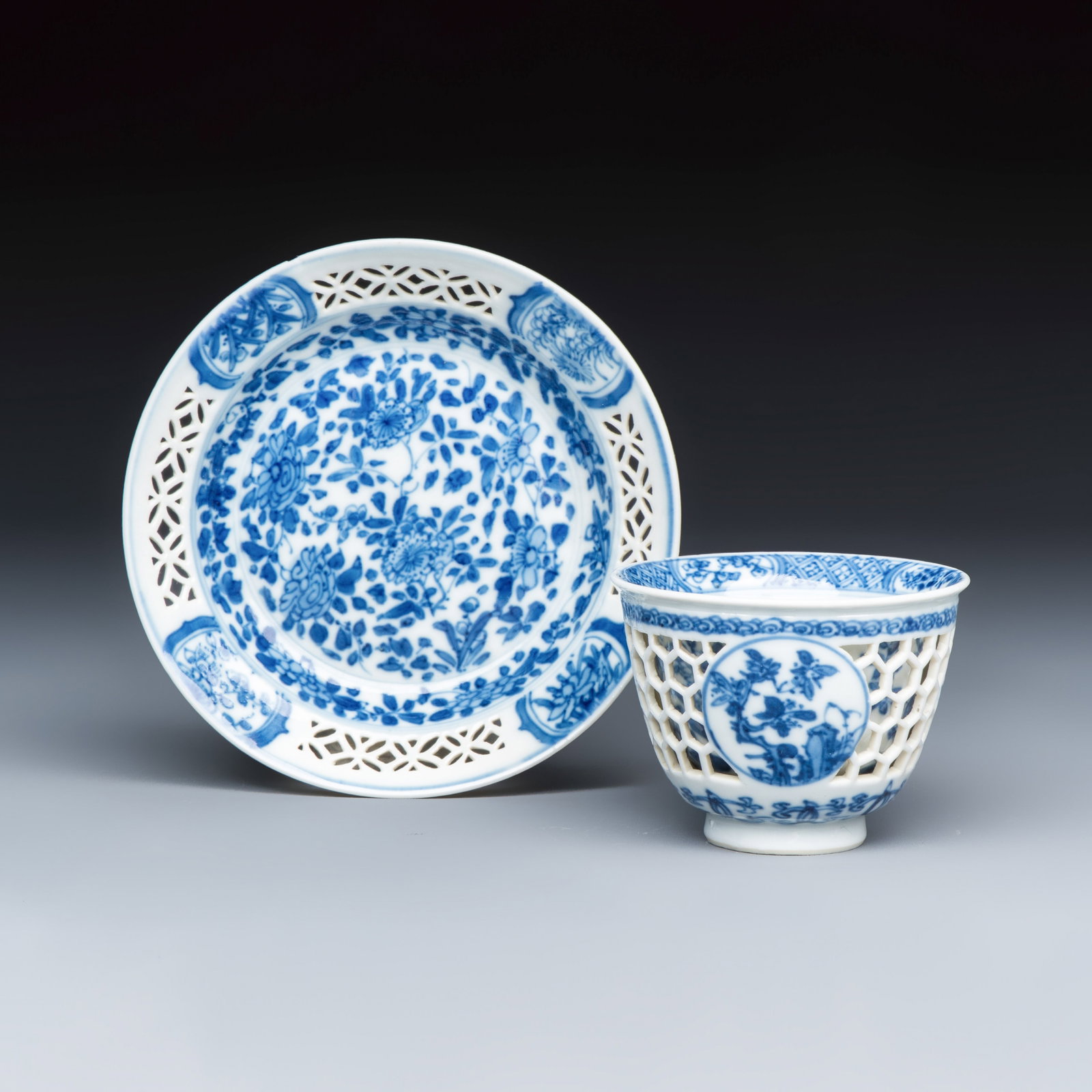 A Chinese blue and white reticulated 'Linglong' tea bowl and saucer, Kangxi (1 of 11)