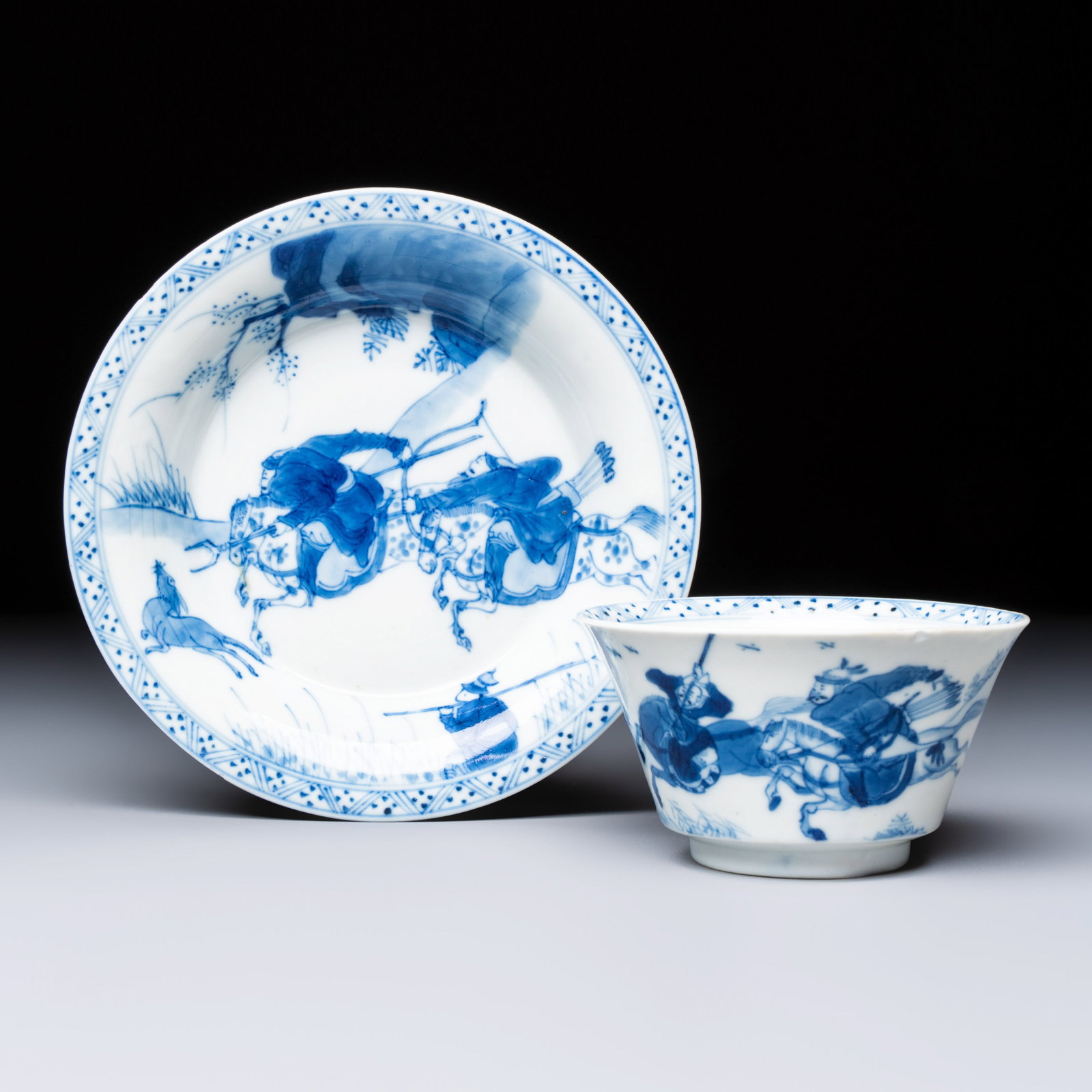 A Chinese blue and white 'Hunting Scene' tea bowl and saucer, jade mark, Kangxi (1 of 9)
