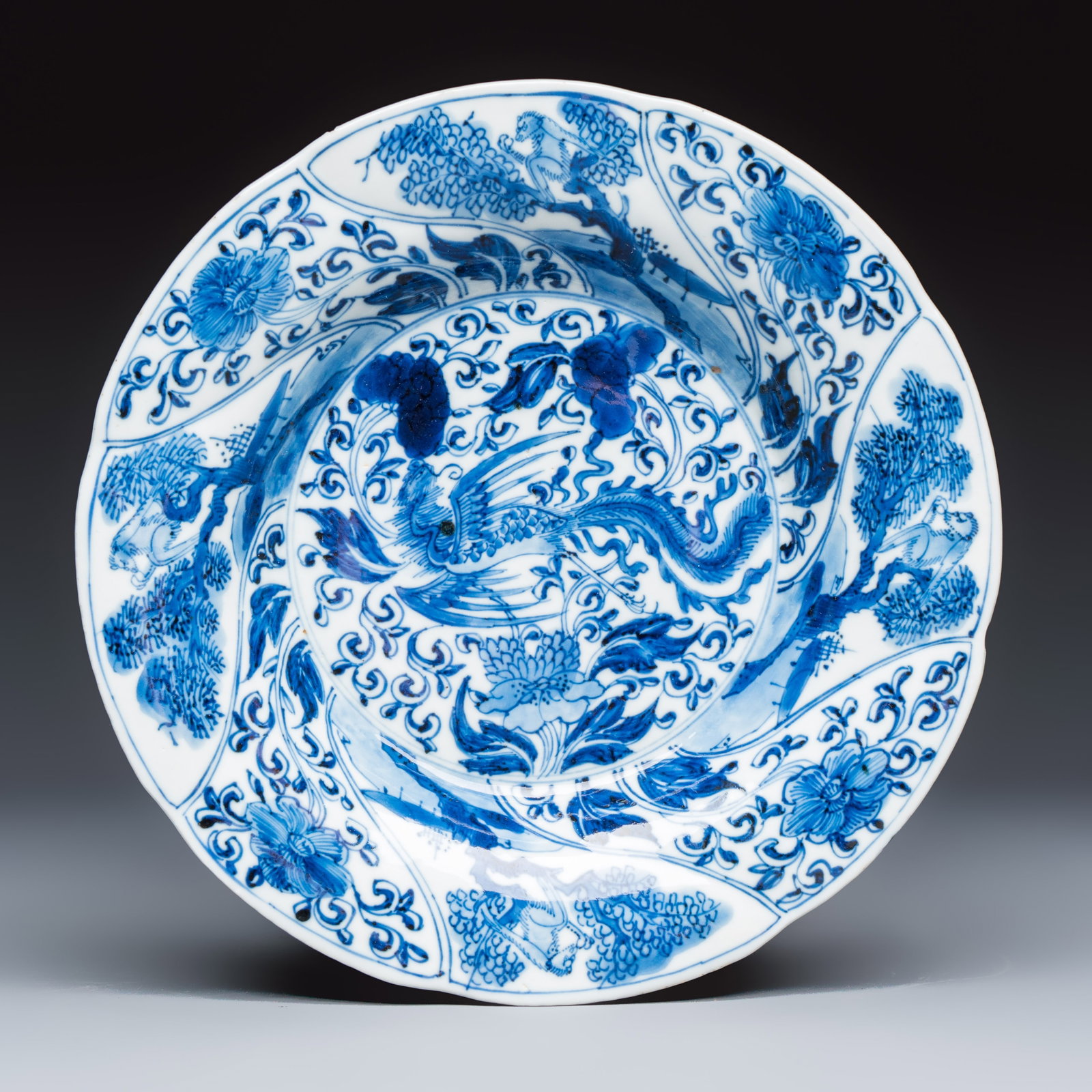 A Chinese blue and white 'Phoenix and Monkeys' lobed plate, flower mark, Kangxi (1 of 2)