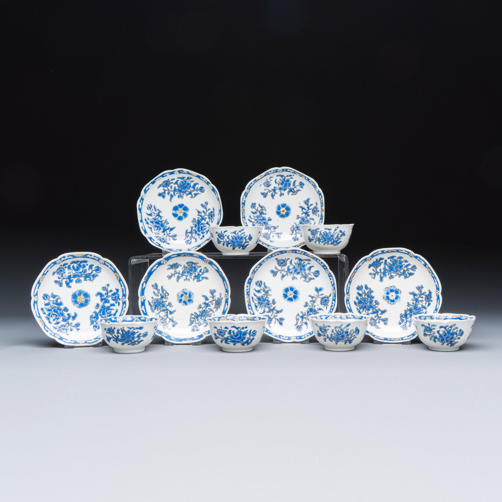 A set of six Chinese blue-enamelled and gilt-decorated tea bowls and saucers with floral design, (1 of 11)