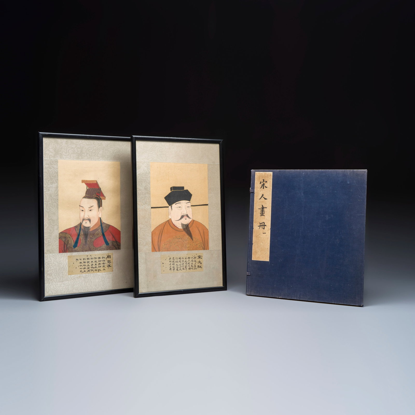 A Chinese 'Song Ren Huace' album and two framed portraits, 20th C.: A Chinese 'Song Ren Huace' album and two framed portraits, 20th C. L.: 30 cm - H.: 47,5 cm | the frames L.: 19 cm - H.: 26,5 cm | the works Dim: 33,5 x 4 x 37,5 cm | the album