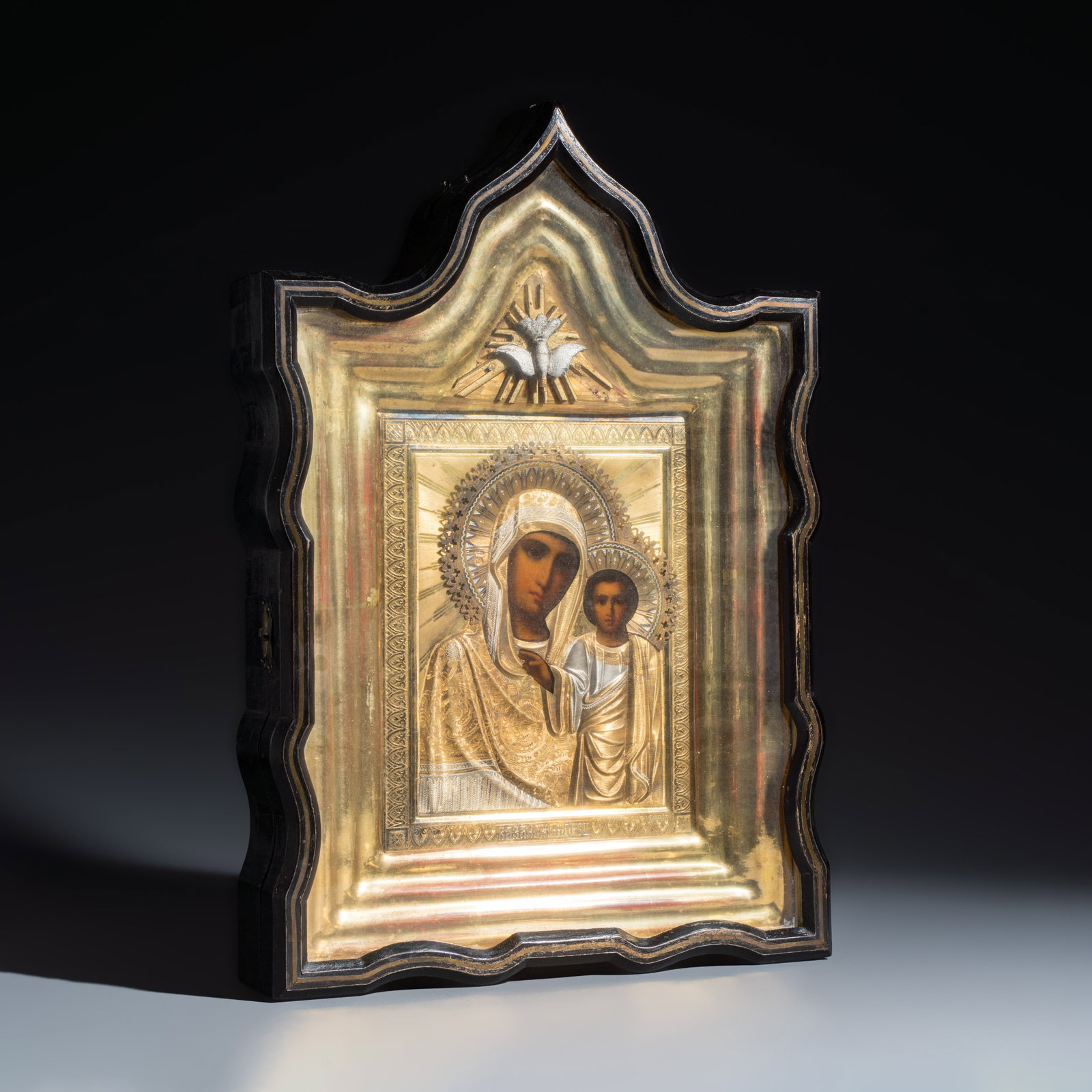 A framed Russian icon of the Kazan Mother of God with a silver-gilt riza, Moscow, ca. 1908: A framed Russian icon of the Kazan Mother of God with a silver-gilt riza, Moscow, ca. 1908 Dim: 42,7 x 29,5 x 7,2 cm | the frame Dim: 21,2 x 17 cm | the riza With the maker's mark of Mikhail Zorin (?)