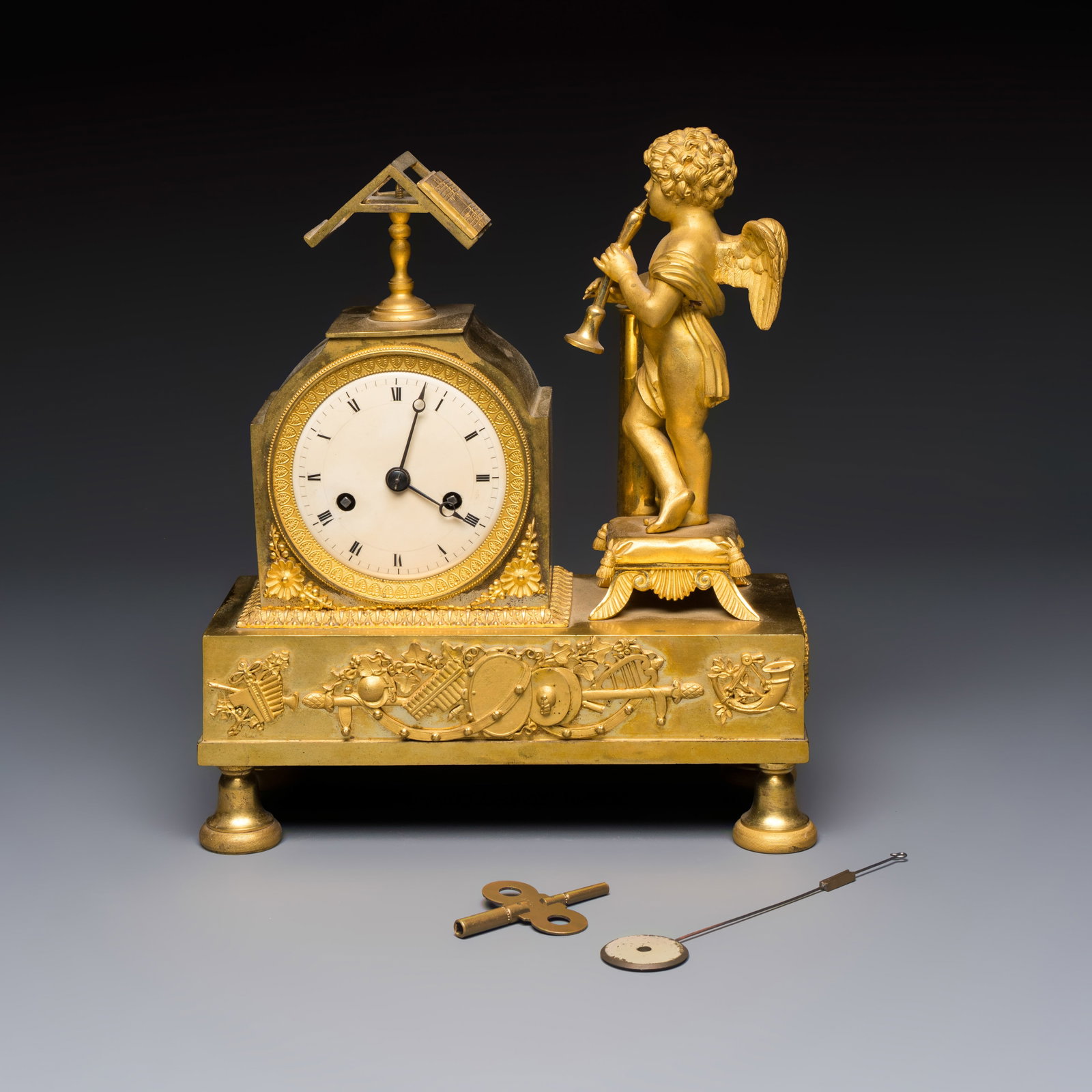 A French fire-gilt bronze mantel clock with a music making cherub, early 19th C. (1 of 7)