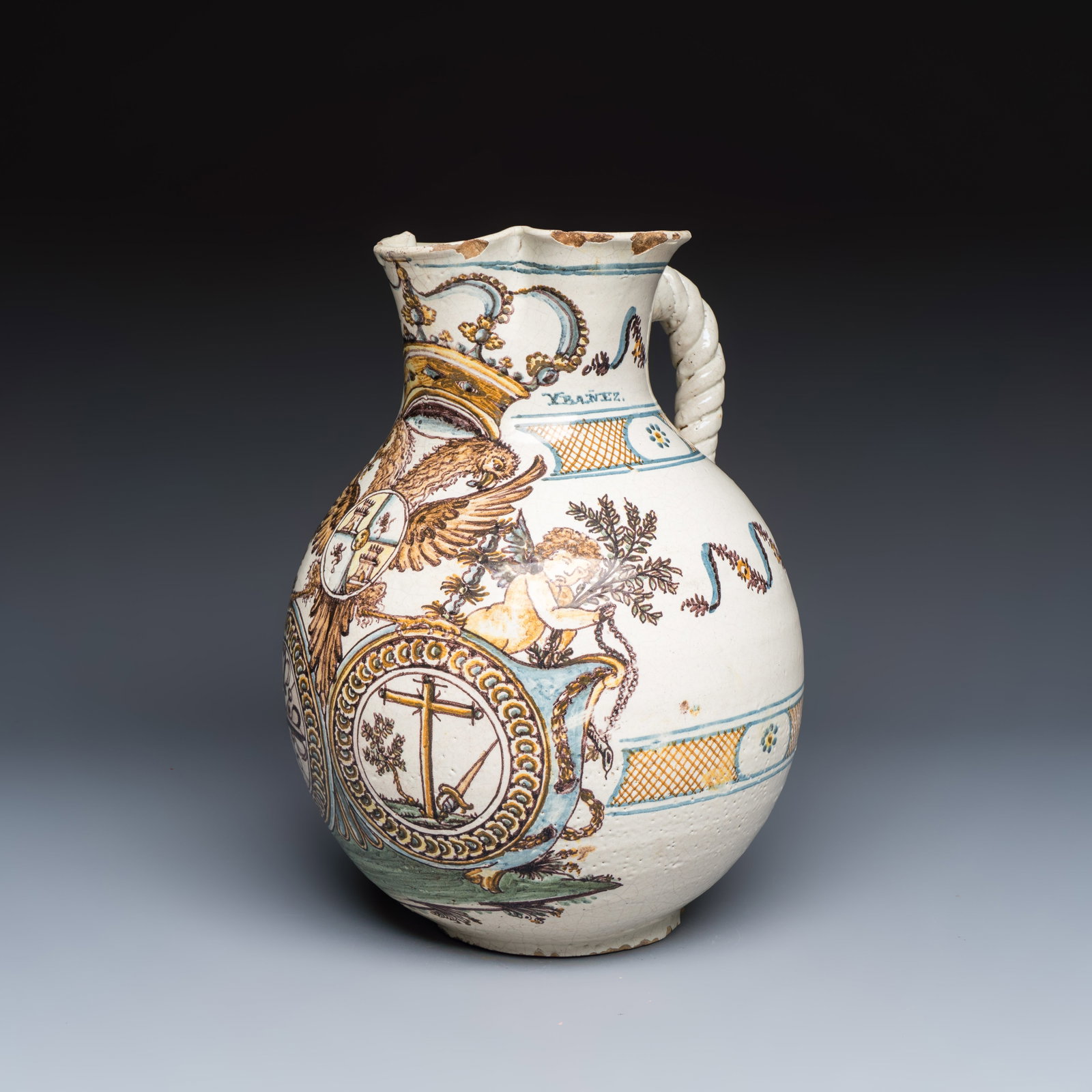 A large polychrome Talavera armorial ewer, Spain, 18th C.: A large polychrome Talavera armorial ewer, Spain, 18th C. H.: 35,5 cm Provenance: A Belgian private collection. Inscribed 'Soy de Don Josef Ibañez'', which translates to: "I belong to Mister Josef Ib