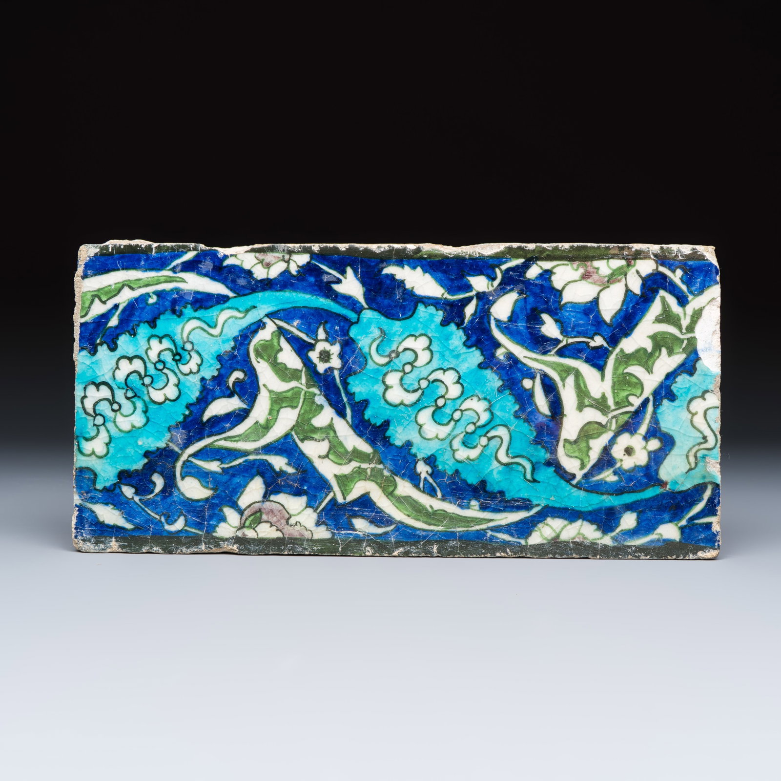 A polychrome Damascus pottery border tile with floral design, 16th C. (1 of 2)