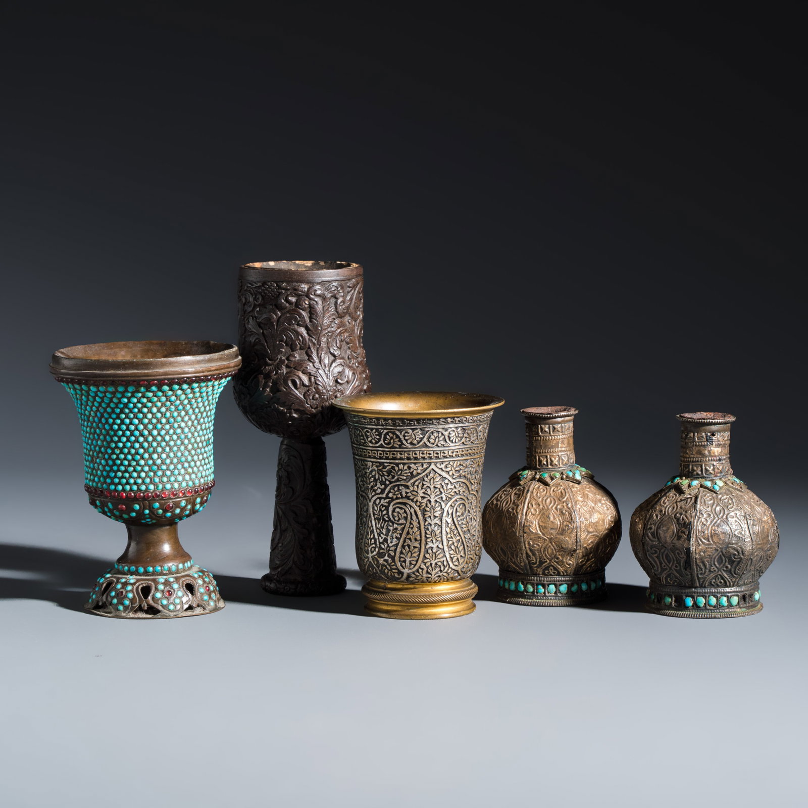 Five Persian repousse, inlaid and turquoise-set metal hookah components, Qajar, 19th C.: Five Persian repousse, inlaid and turquoise-set metal hookah components, Qajar, 19th C. H.: 12 cm | the tallest H.: 7 cm | the smallest Total weight: 859 grams