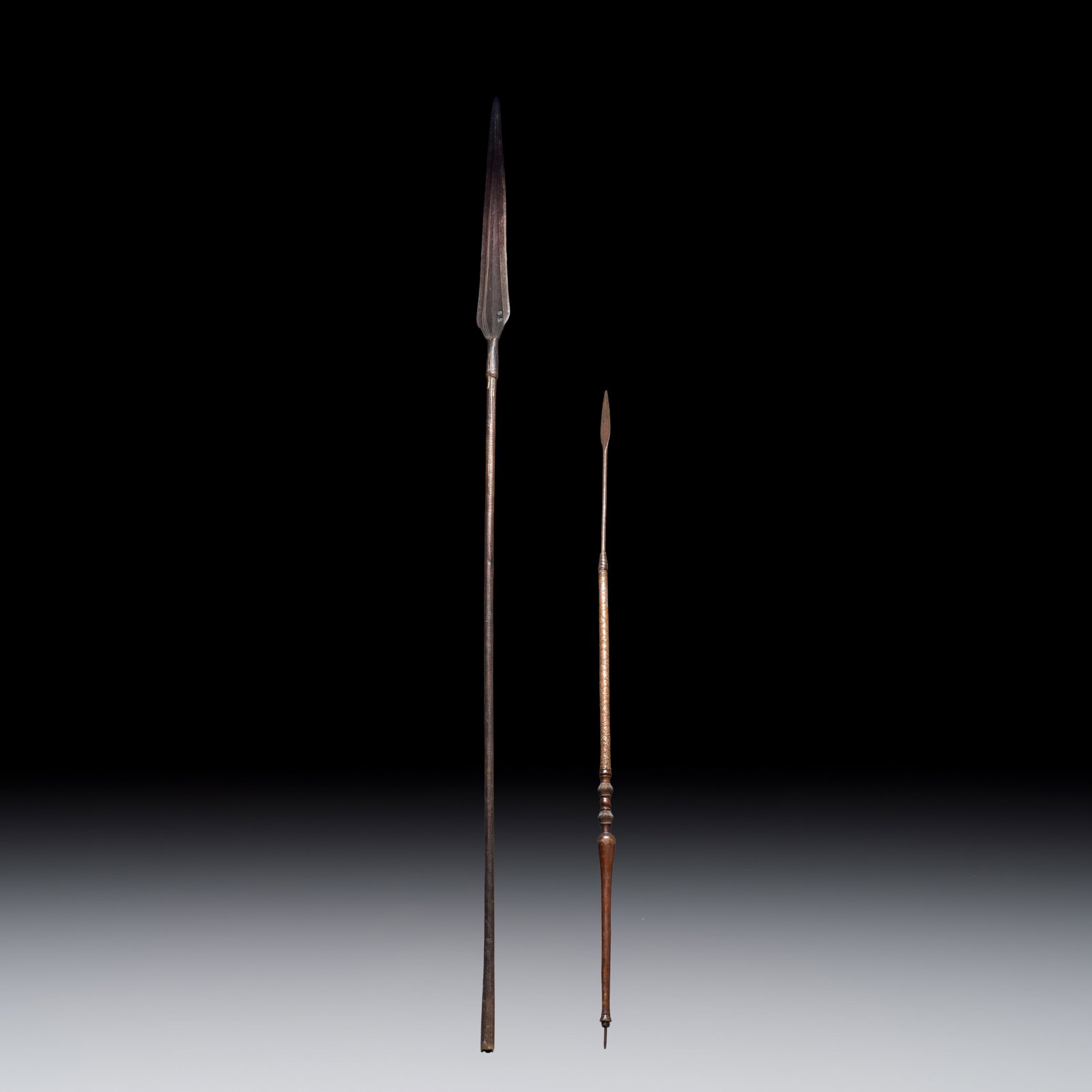 Two African tribal iron and wood spears, 19/20th C.: Two African tribal iron and wood spears, 19/20th C. L.: 205,5 cm | the longest L.: 154 cm | the shortest