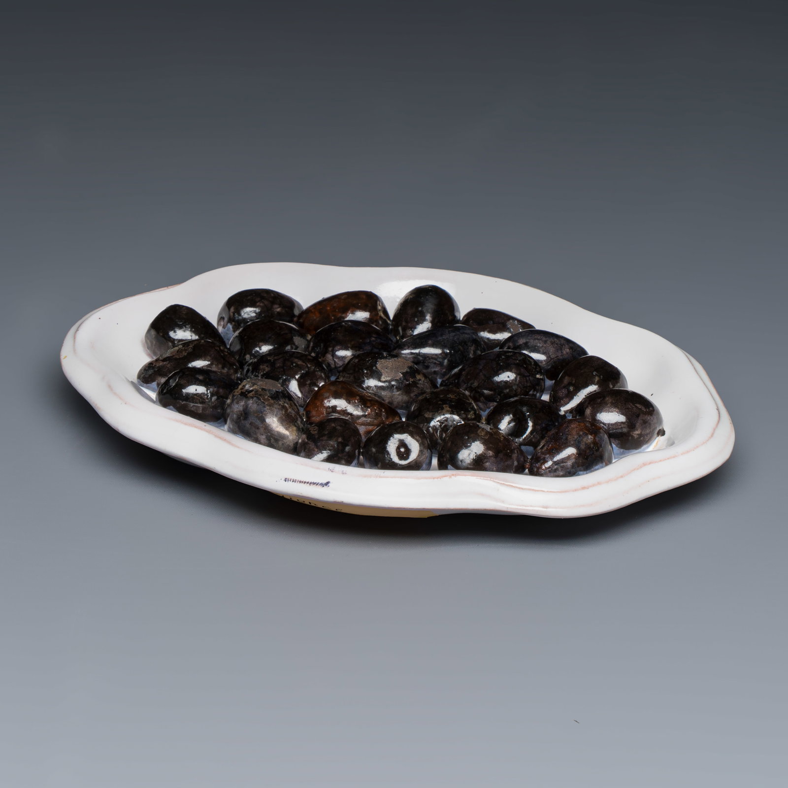 A Moustiers faience trompe-l'oeil dish with olives, France, 18th C. (1 of 3)