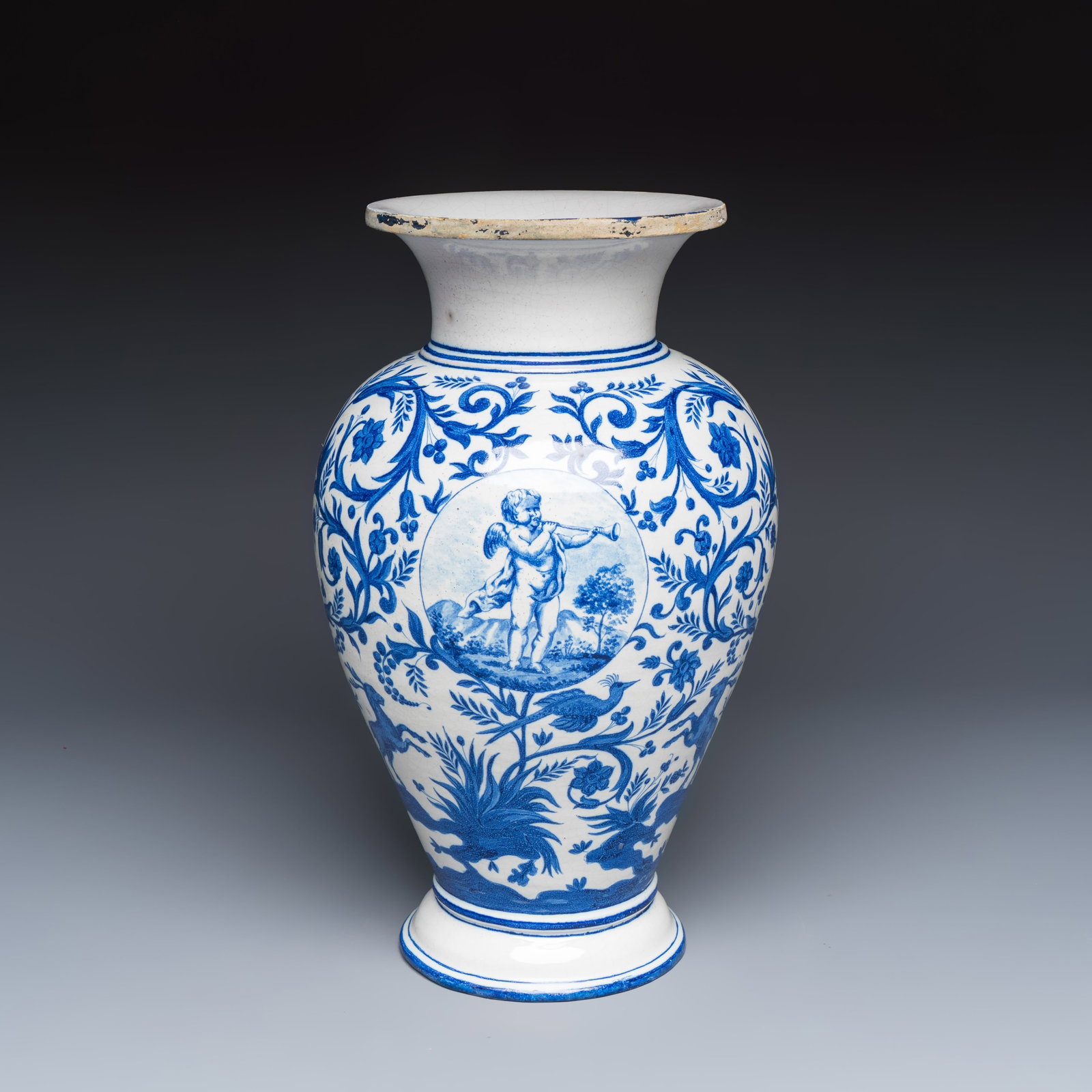 A rare blue and white Brussels faience vase with a cherub trumpeter, Stevens workshop, 19th C.: A rare blue and white Brussels faience vase with a cherub trumpeter, Stevens workshop, 19th C. H.: 38,6 cm Provenance: A Belgian private collection.