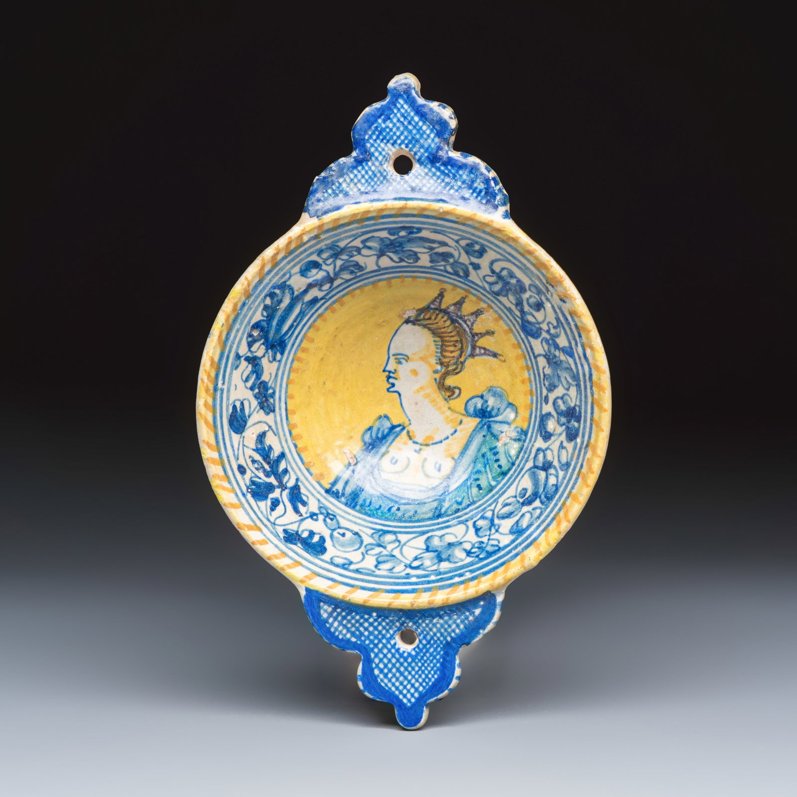 An extremely rare maiolica porringer with the portrait of a queen or goddess, Antwerp, last quarter: An extremely rare maiolica porringer with the portrait of a queen or goddess, Antwerp, last quarter 16th C. L.: 23,5 cm - H.: 6 cm Provenance: The collection of A. Vrij, The Netherlands. The collectio