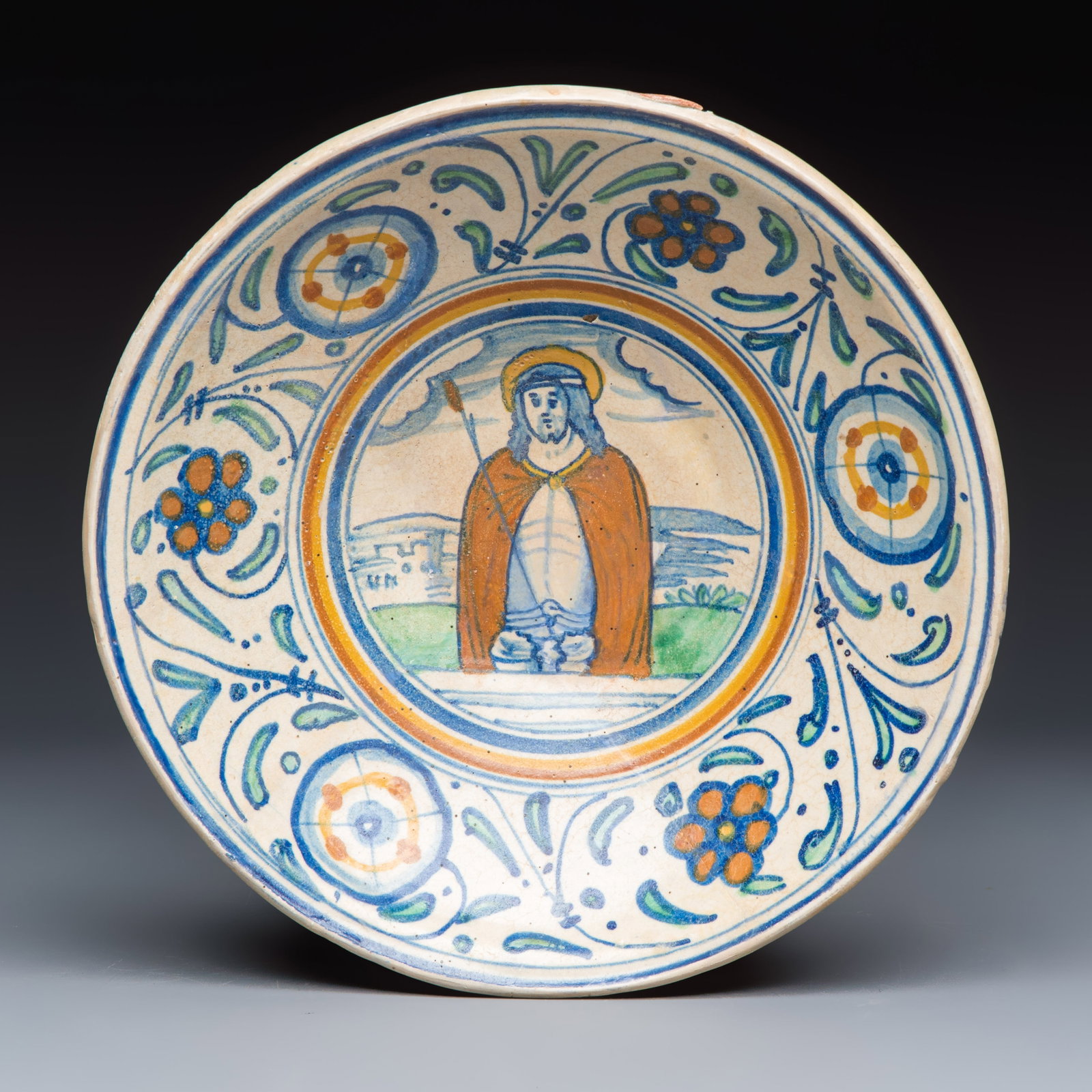 A rare polychrome maiolica dish with 'Christ as the Man of Sorrows', Antwerp, ca. 1540-1550: A rare polychrome maiolica dish with 'Christ as the Man of Sorrows', Antwerp, ca. 1540-1550 Dia.: 22 cm Provenance: A private collection, Mechelen, as published in the publication Referred to below. A