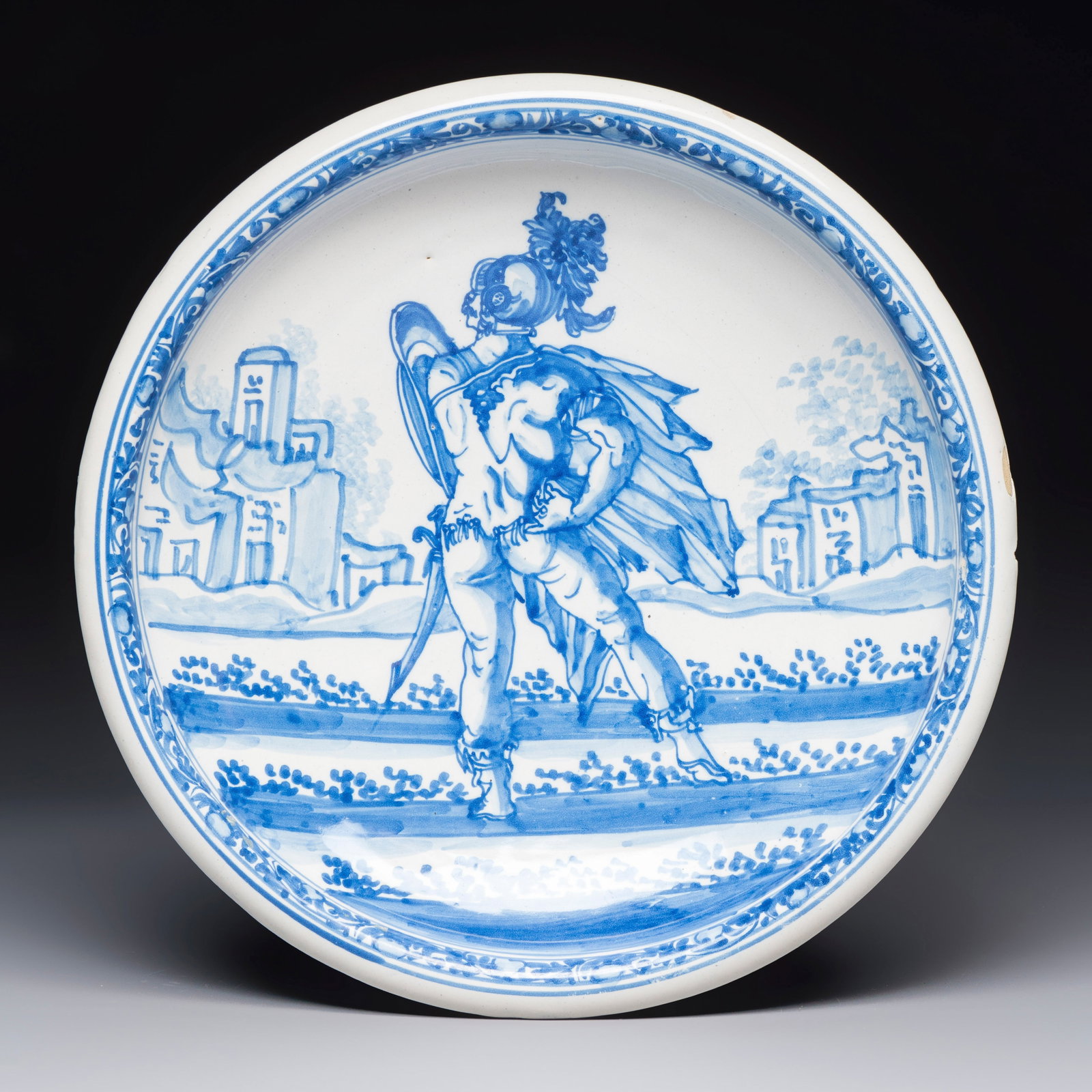 A blue and white Dutch Delft 'Marcus Valerius Corvus' dish, after an engraving by Hendrick Goltzius,: A blue and white Dutch Delft 'Marcus Valerius Corvus' dish, after an engraving by Hendrick Goltzius, 17th C. Dia.: 33 cm The scene on this dish is directly copied from an engraving by Dutch artist Hen