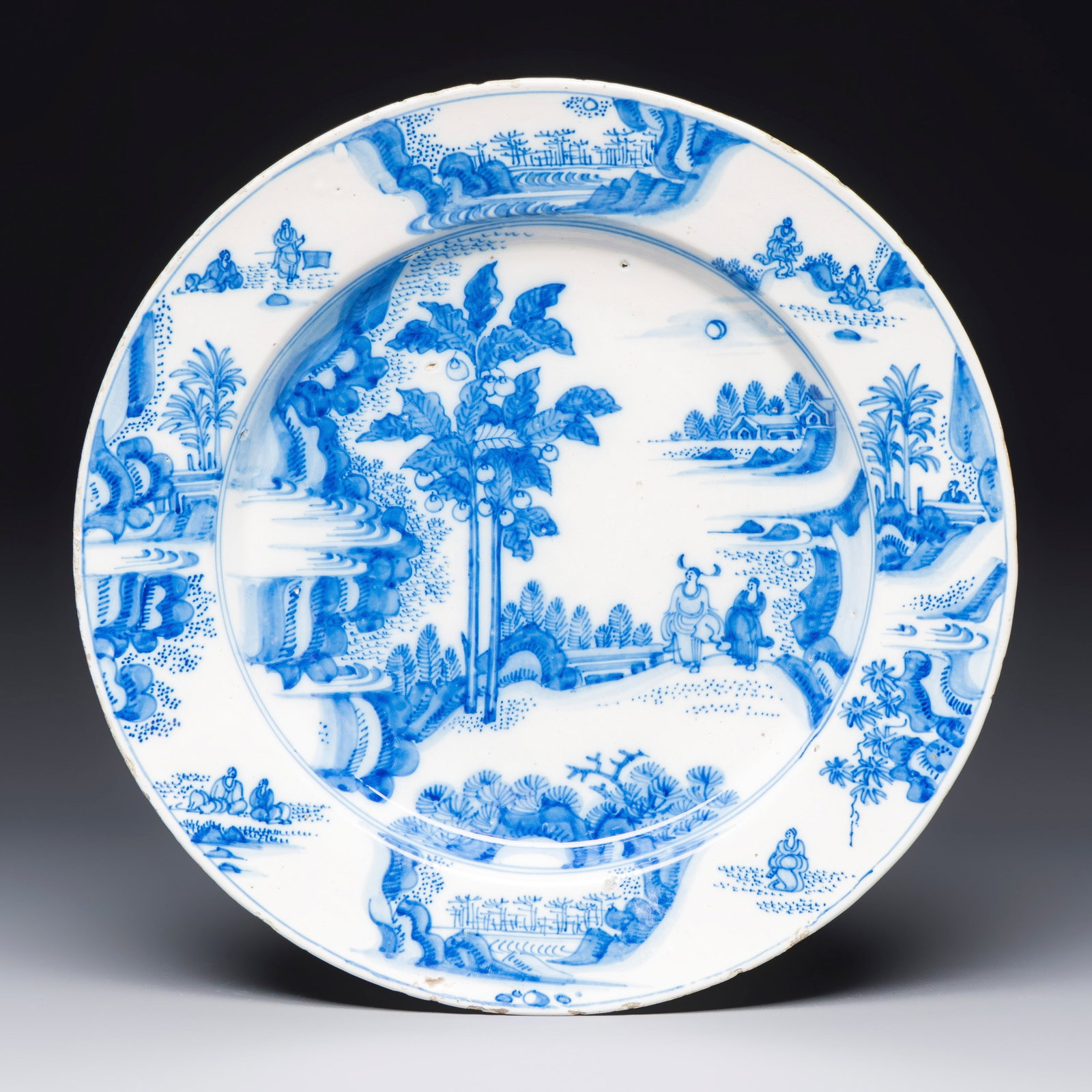 A large blue and white Dutch Delft chinoiserie dish with landscape and figural design, 17th C.: A large blue and white Dutch Delft chinoiserie dish with landscape and figural design, 17th C. Dia.: 39 cm