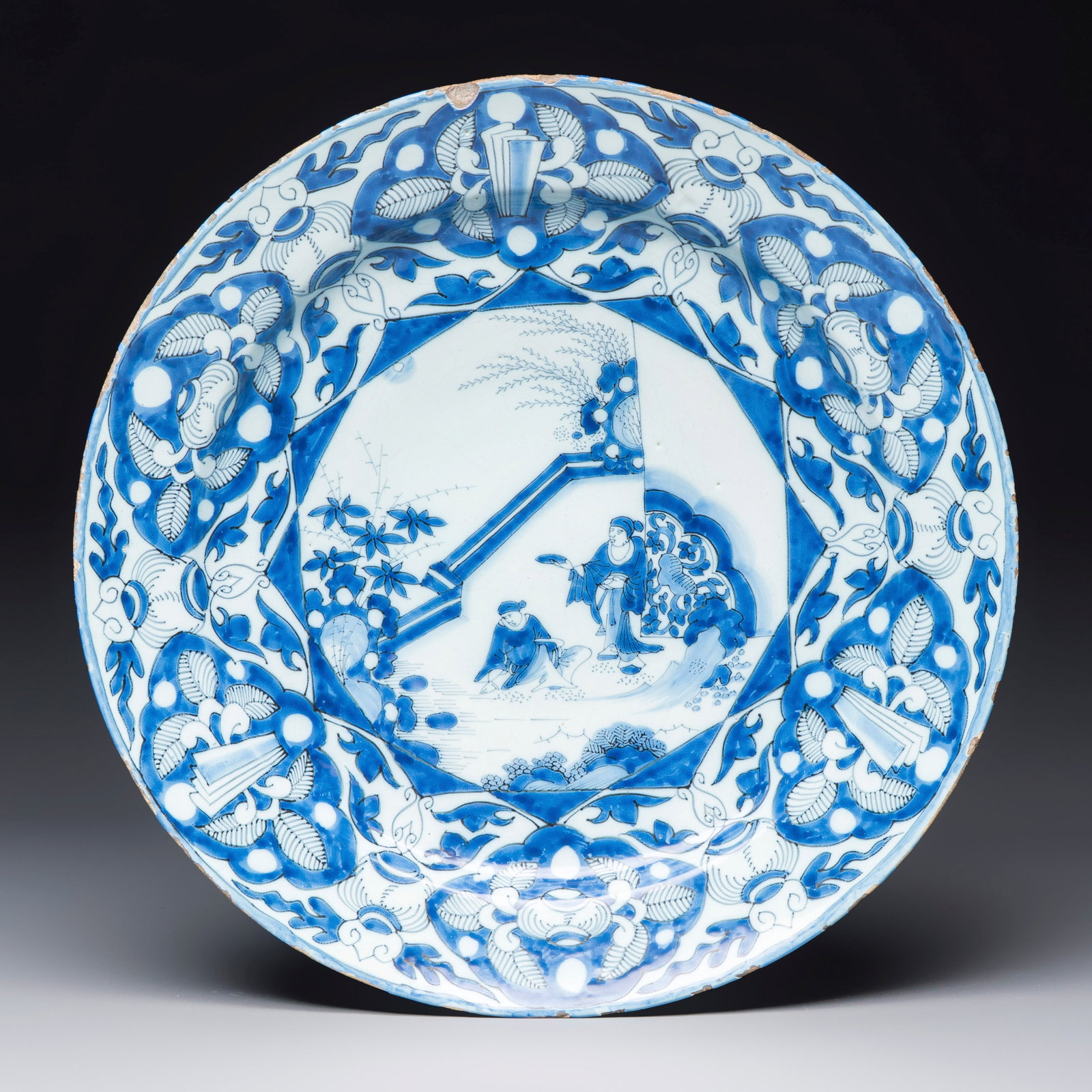 A blue and white Dutch Delft chinoiserie dish with figural design, early 18th C.: A blue and white Dutch Delft chinoiserie dish with figural design, early 18th C. Dia.: 39 cm