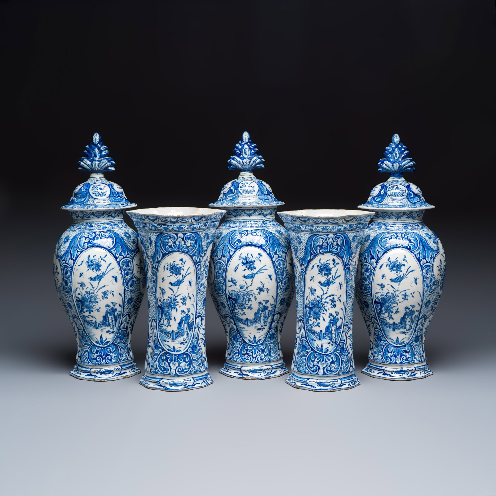 A fine blue and white Dutch Delft five-piece chinoiserie garniture, 1st quarter 18th C.: A fine blue and white Dutch Delft five-piece chinoiserie garniture, 1st quarter 18th C. H.: 52,5 cm | the tallest, incl. cover H.: 36,6 cm | the smallest Provenance: Stodel Collection, with their labe