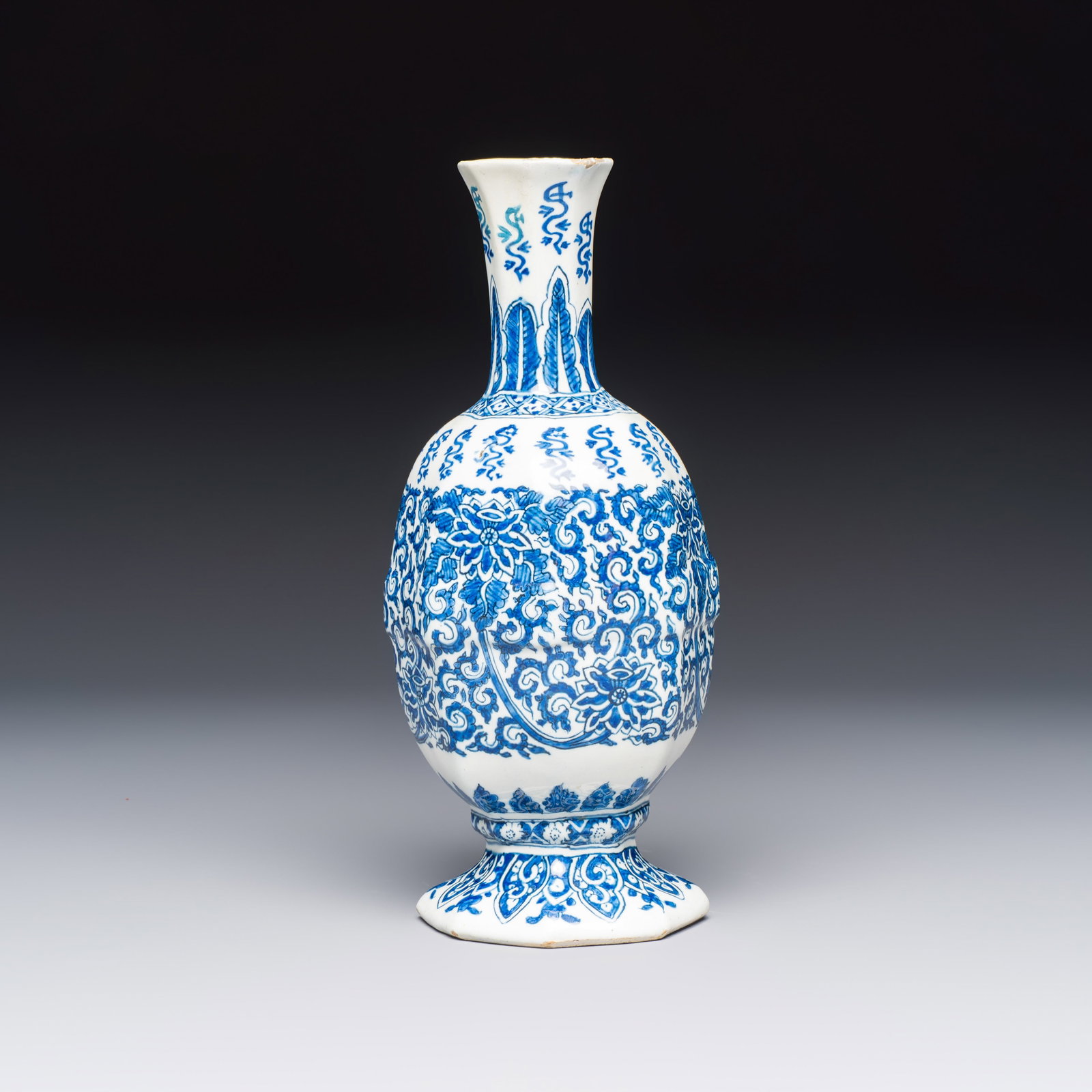 A blue and white Dutch Delft bottle vase with lotus scrolls, 17th C.: A blue and white Dutch Delft bottle vase with lotus scrolls, 17th C. H.: 23 cm Provenance: With a label of 'Art Ceramique Ancien Nicolier, Expert', Paris, France. Marked No. 8 AK on the basefor Adrian