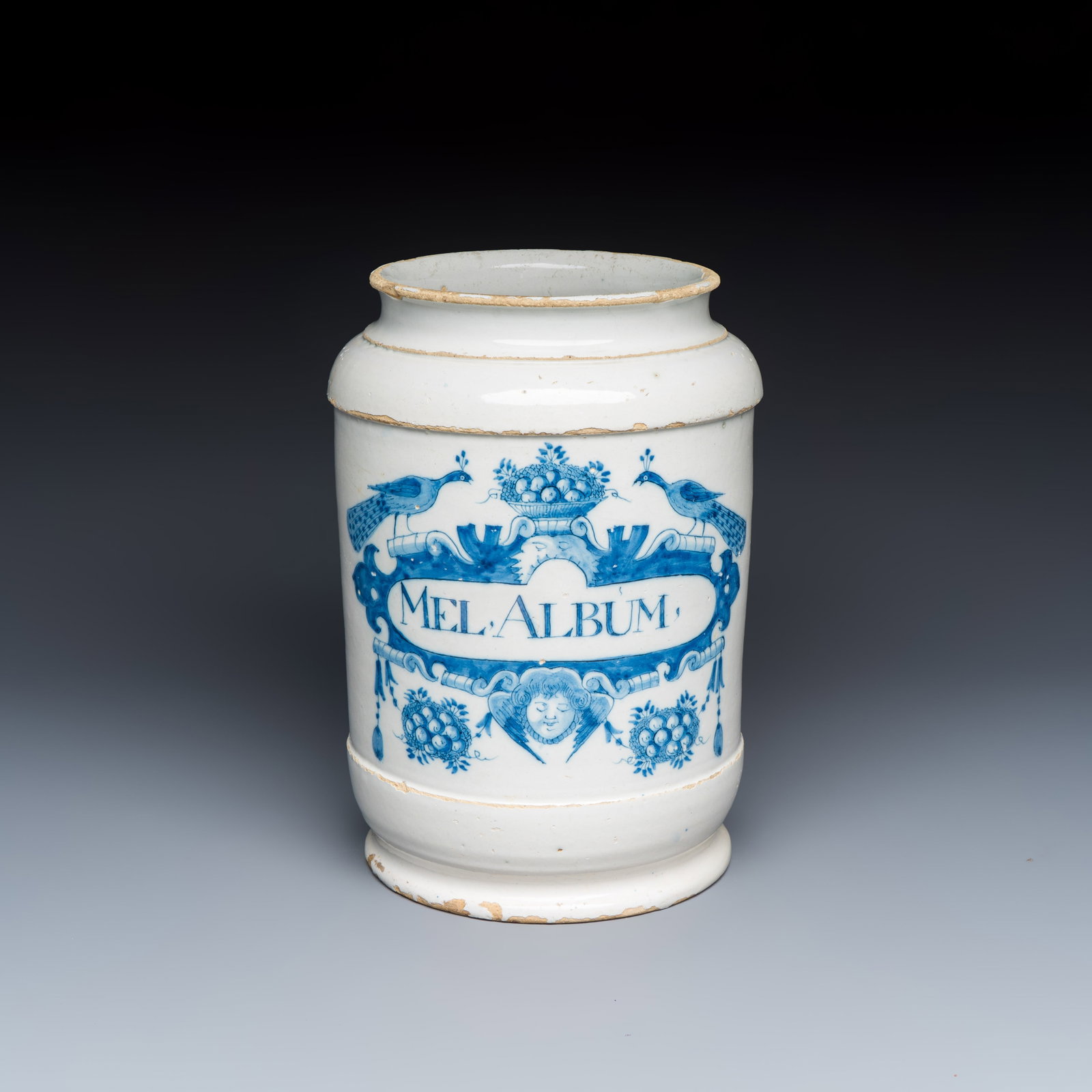 A large blue and white Dutch Delft albarello inscribed 'MEL ALBUM', 18th C.: A large blue and white Dutch Delft albarello inscribed 'MEL ALBUM', 18th C. H.: 26 cm Provenance: Van Nie and Winnubst Antiquairs, Amsterdam, with their label to the base. A Dutch private collection.