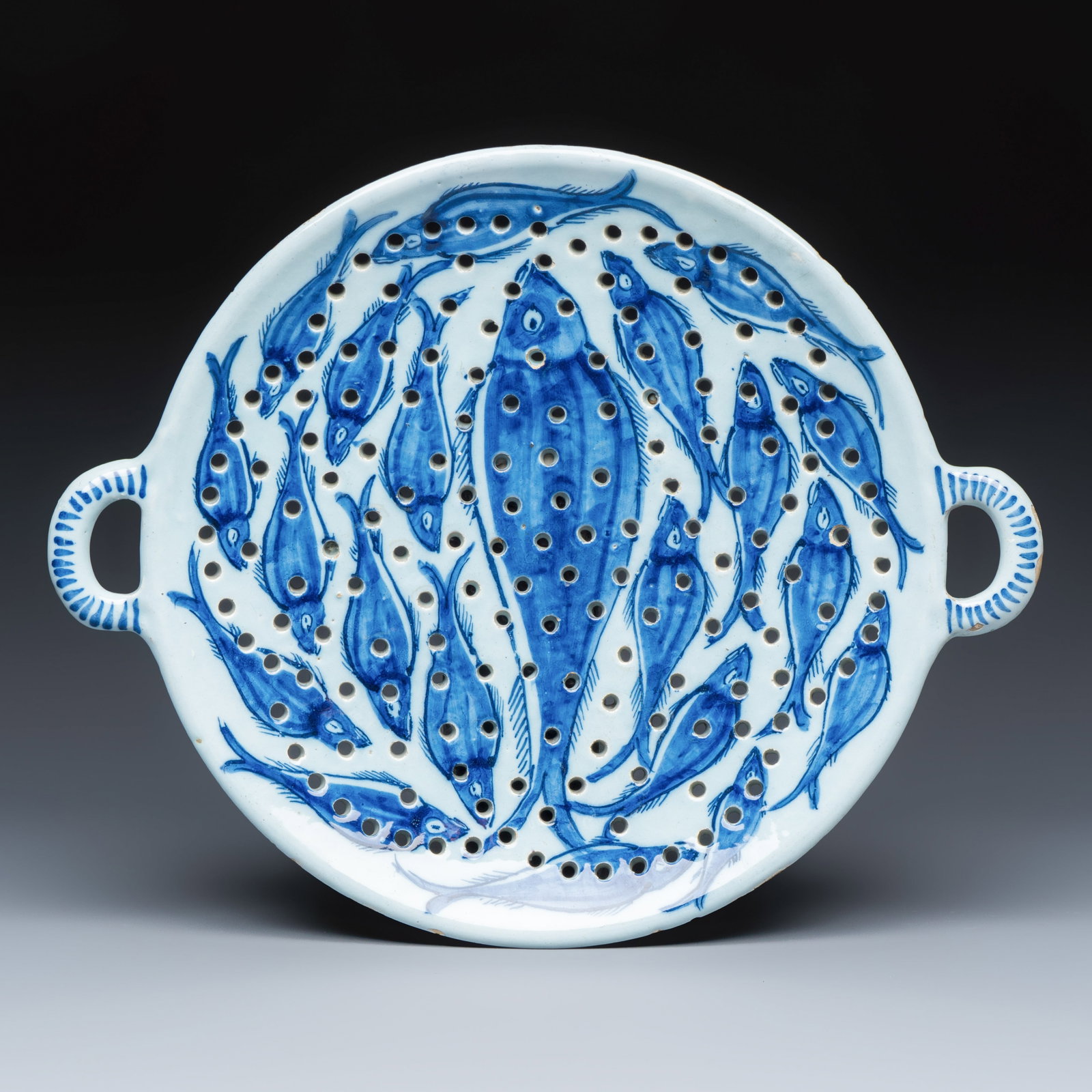 A large blue and white Dutch Delft fish strainer, 18th C. (1 of 3)