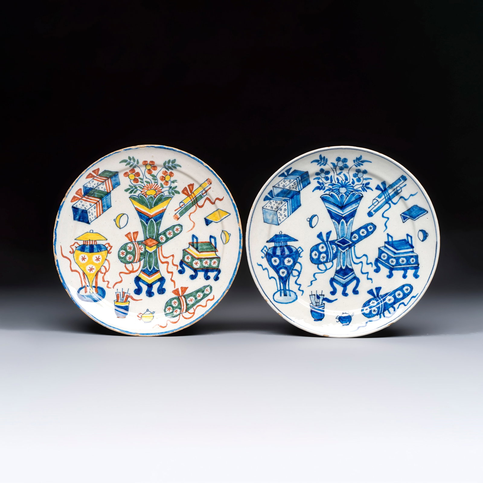 A pair of Dutch Delft blue and white and polychrome ‘Hundred Antiques’ plates, 18th C. (1 of 2)