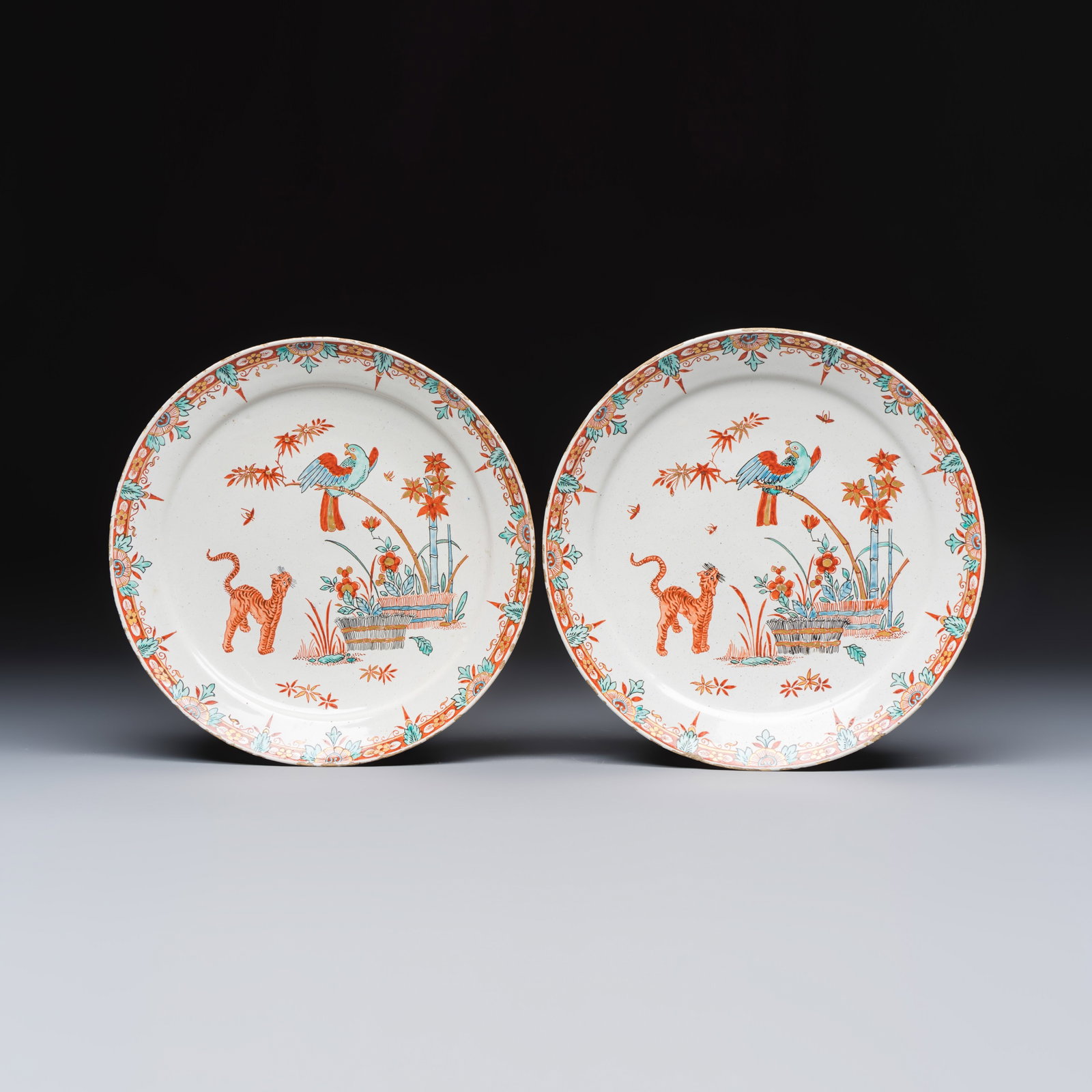 A pair of dore Kakiemon-style Dutch Delft plates with a parrot and tiger, early 18th C.: A pair of dore Kakiemon-style Dutch Delft plates with a parrot and tiger, early 18th C. Dia.: 23 cm Provenance: Paul Blancan Collection, France, collection no. 66, with a label to the reverse of one. 