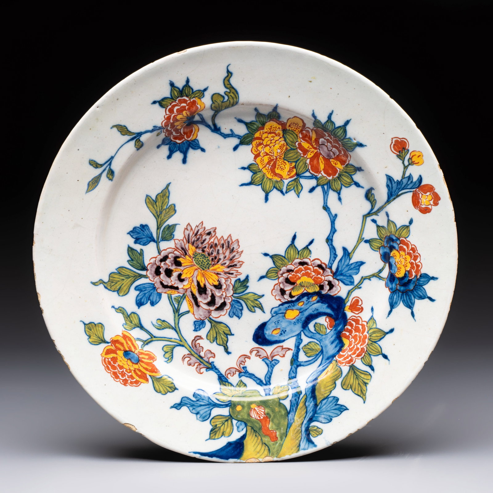 A fine polychrome Dutch Delft plate with floral design, late 17th C. (1 of 2)