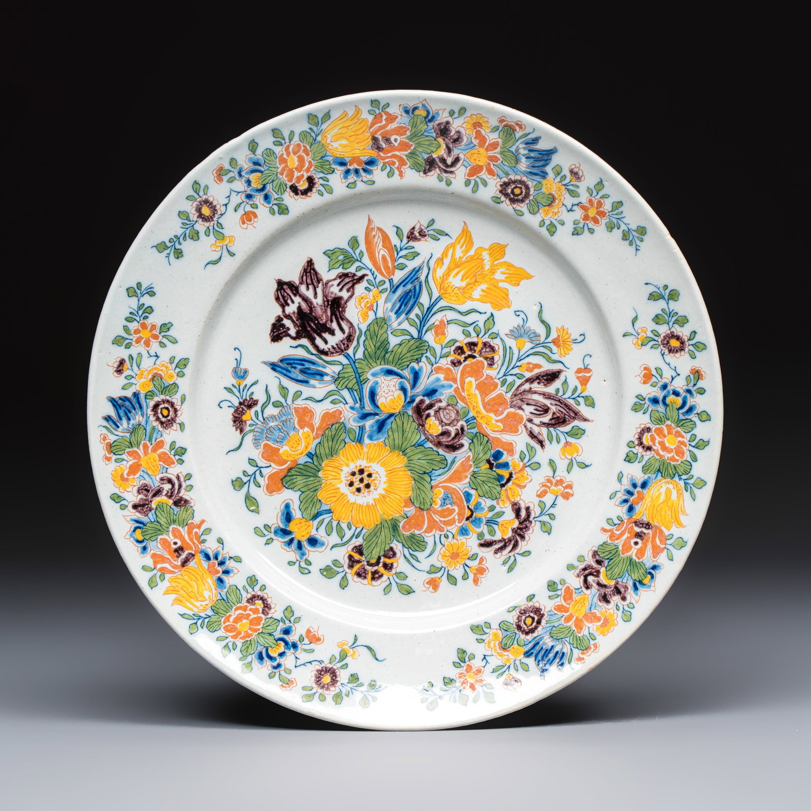 A polychrome Dutch Delft plate with floral design, ca. 1740-60 (1 of 2)