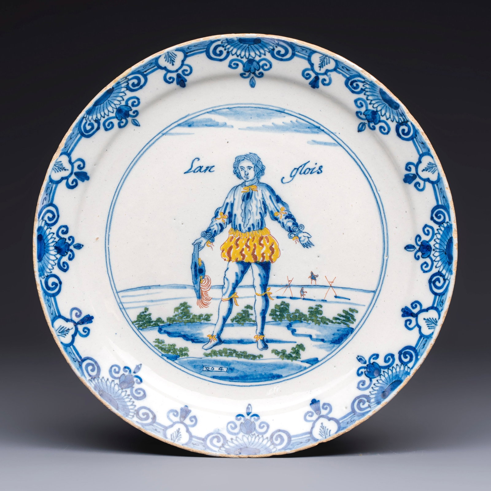 A polychrome Dutch Delft plate inscribed 'Langlois', 1st half 18th C. (1 of 2)