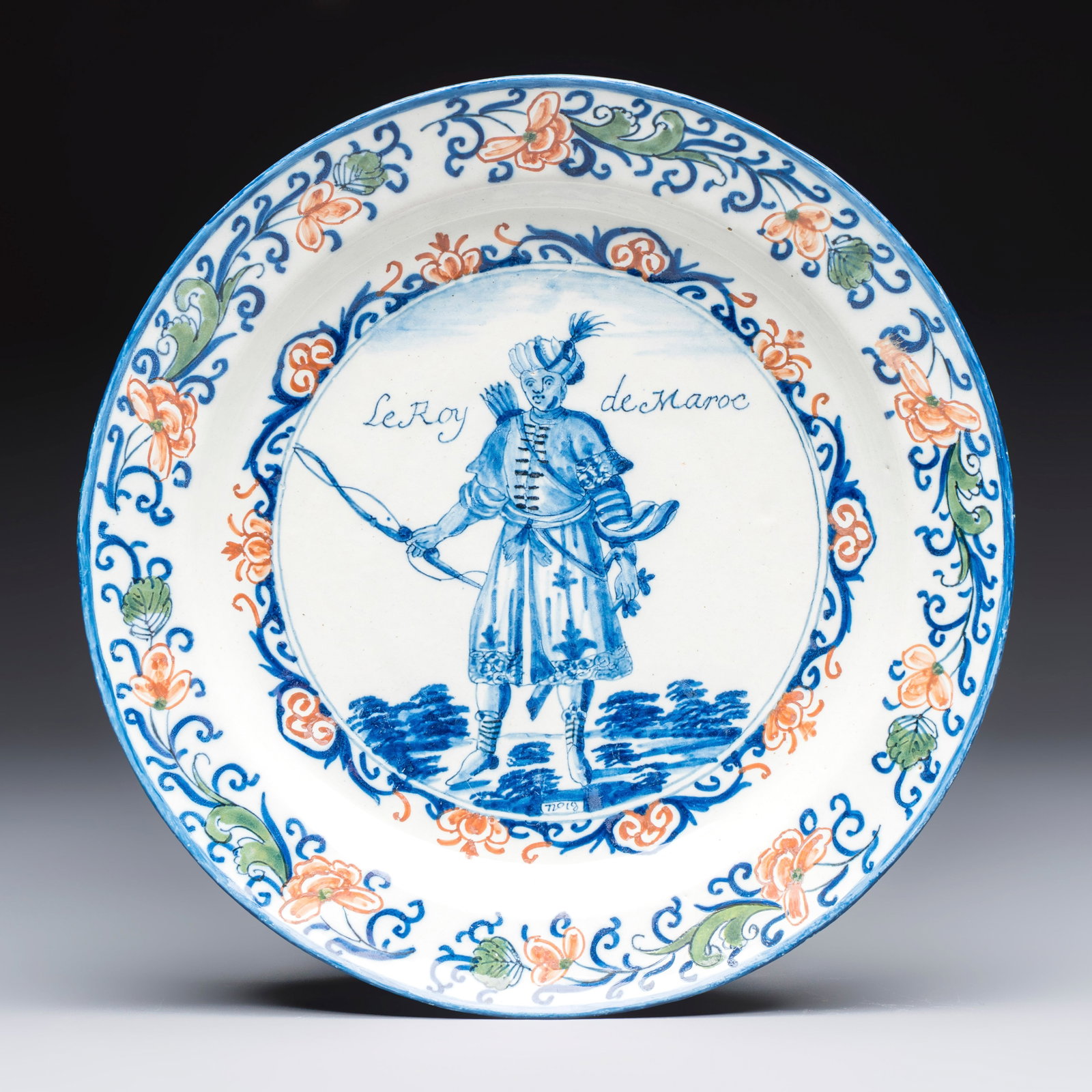 A polychrome Dutch Delft plate inscribed 'Le Roy de Maroc', 1st half 18th C.: A polychrome Dutch Delft plate inscribed 'Le Roy de Maroc', 1st half 18th C. Dia.: 22,1 cm Marked AR on the back for Adriaa[e]n van Rijsselberg[h], the 'De Grieksche A' workshop, Delft, ca. 1701 or po