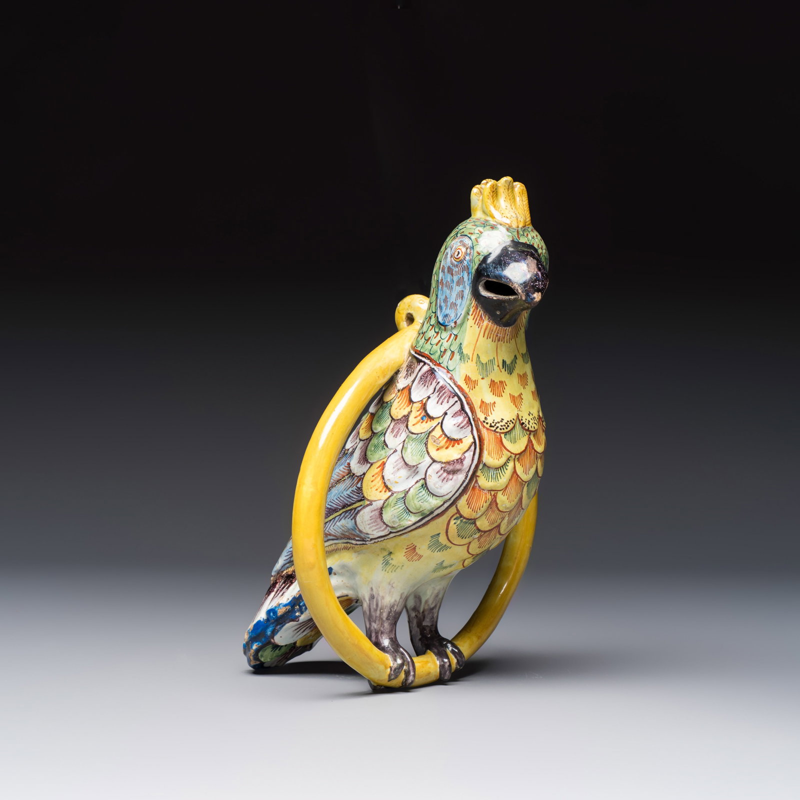 A fine polychrome Dutch Delft model of a parrot on a ring, 18th C.: A fine polychrome Dutch Delft model of a parrot on a ring, 18th C. H.: 27,4 cm