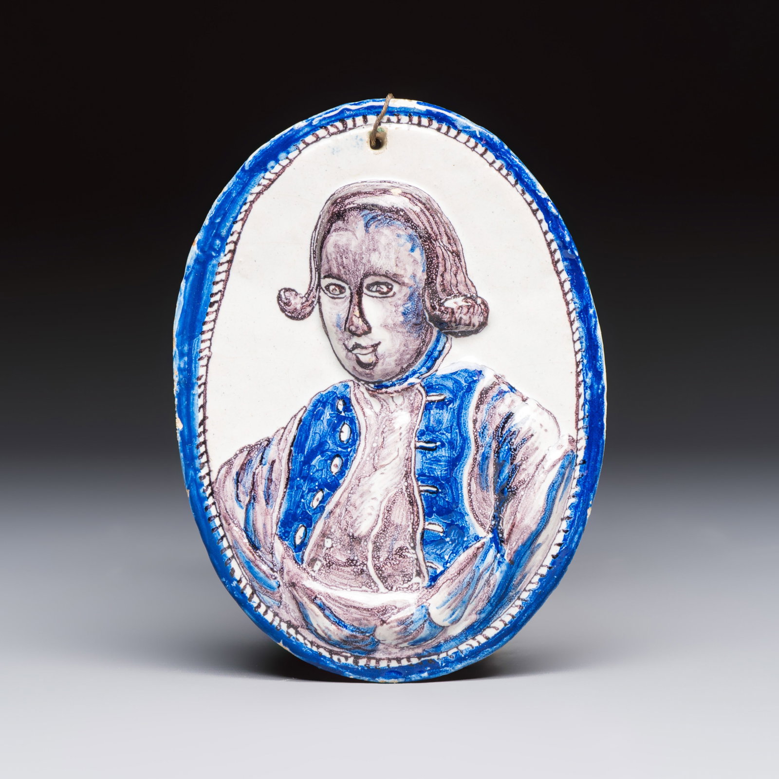 A blue, white and manganese Dutch or English Delftware portrait medallion, 18/19th C. (1 of 2)